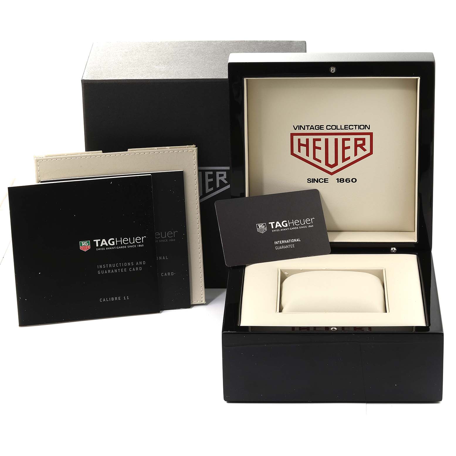 This image shows the packaging and accessories for a Tag Heuer Limited Edition CAW211D Men
s Stainless Steel Blue Dial CAW211D Men
s Stainless Steel Blue Dial watch, including the box, cushion, and warranty card.
