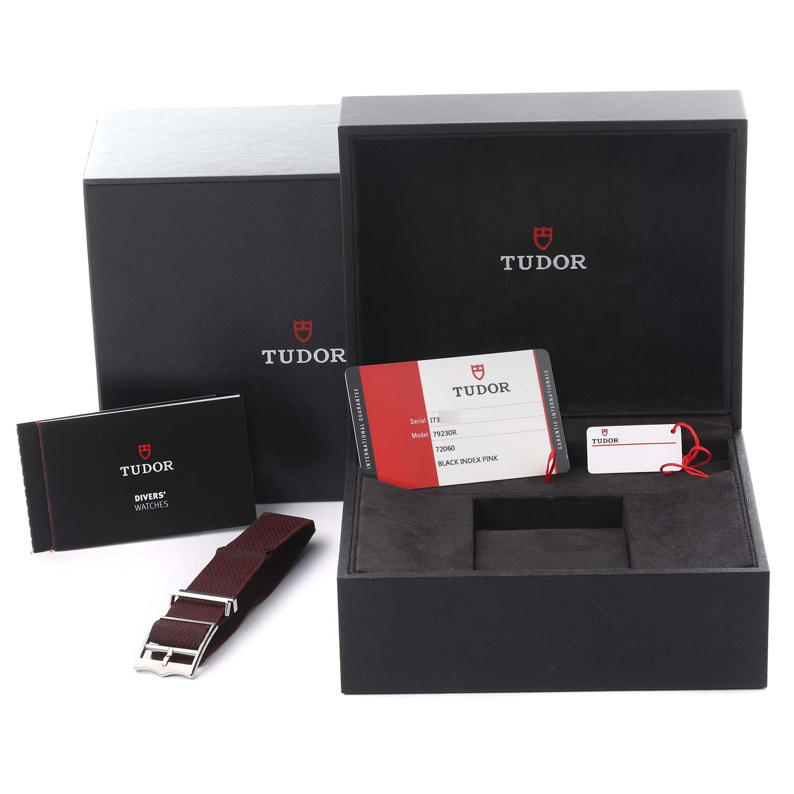 The image shows Tudor Heritage Black Bay 79230R-0003 Men's Stainless Steel Black Dial 79230R-0003 Men's Stainless Steel Black Dial packaging, warranty card, tag, booklet, and an additional strap, viewed from above.