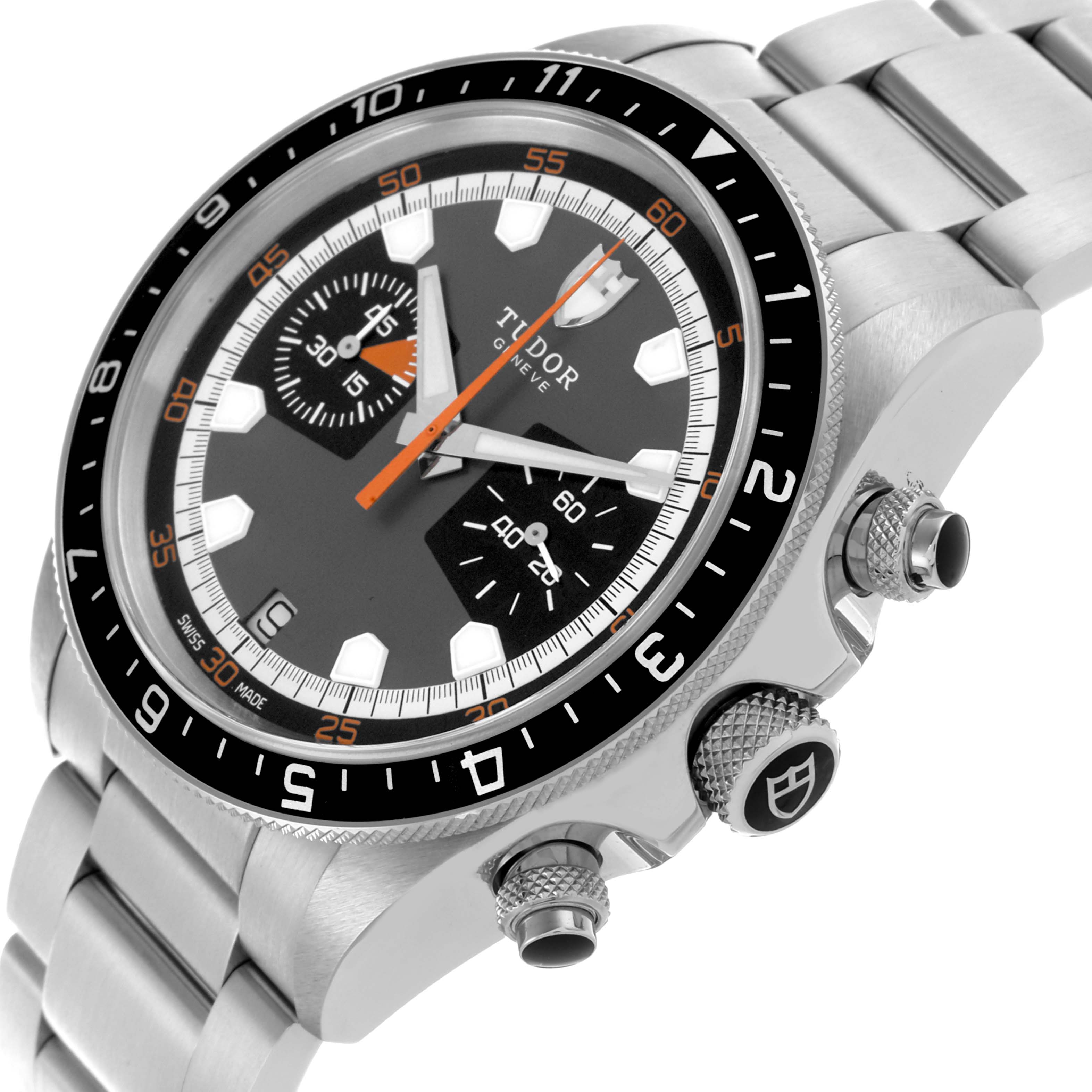 The image shows a Heritage Chrono watch by Tudor from an angled side view, highlighting the bezel, dial, and chronograph pushers.
