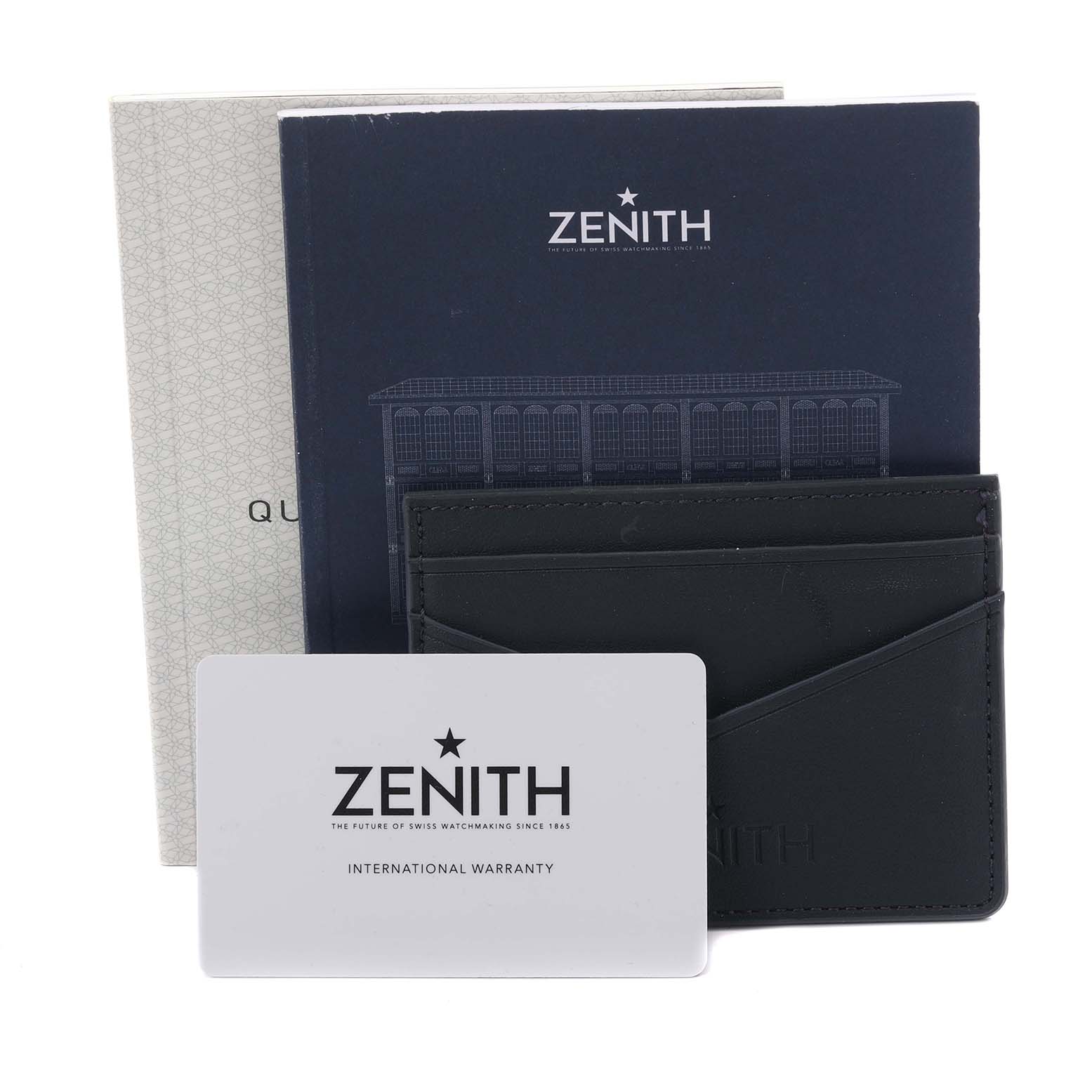 The image shows the Zenith 16.3200.3600/03/C906 Women's Stainless Steel Silver Dial 16.3200.3600/03/C906 Women's Stainless Steel Silver Dial Chronomaster's packaging accessories, including the box, warranty card, and documentation, from a front angle.