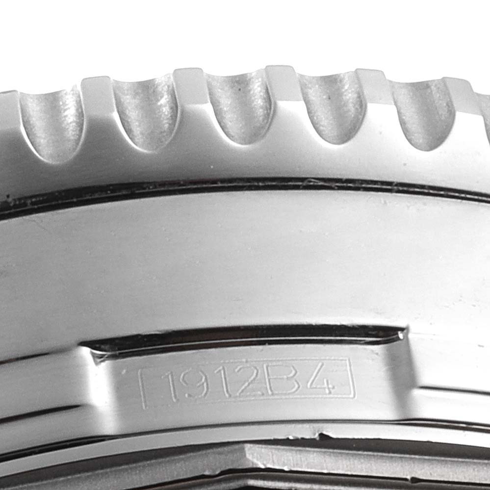 This close-up image displays the textured bezel and part of the engraved case back of a Breitling Navitimer A24322 Men's Stainless Steel Black Dial A24322 Men's Stainless Steel Black Dial watch.