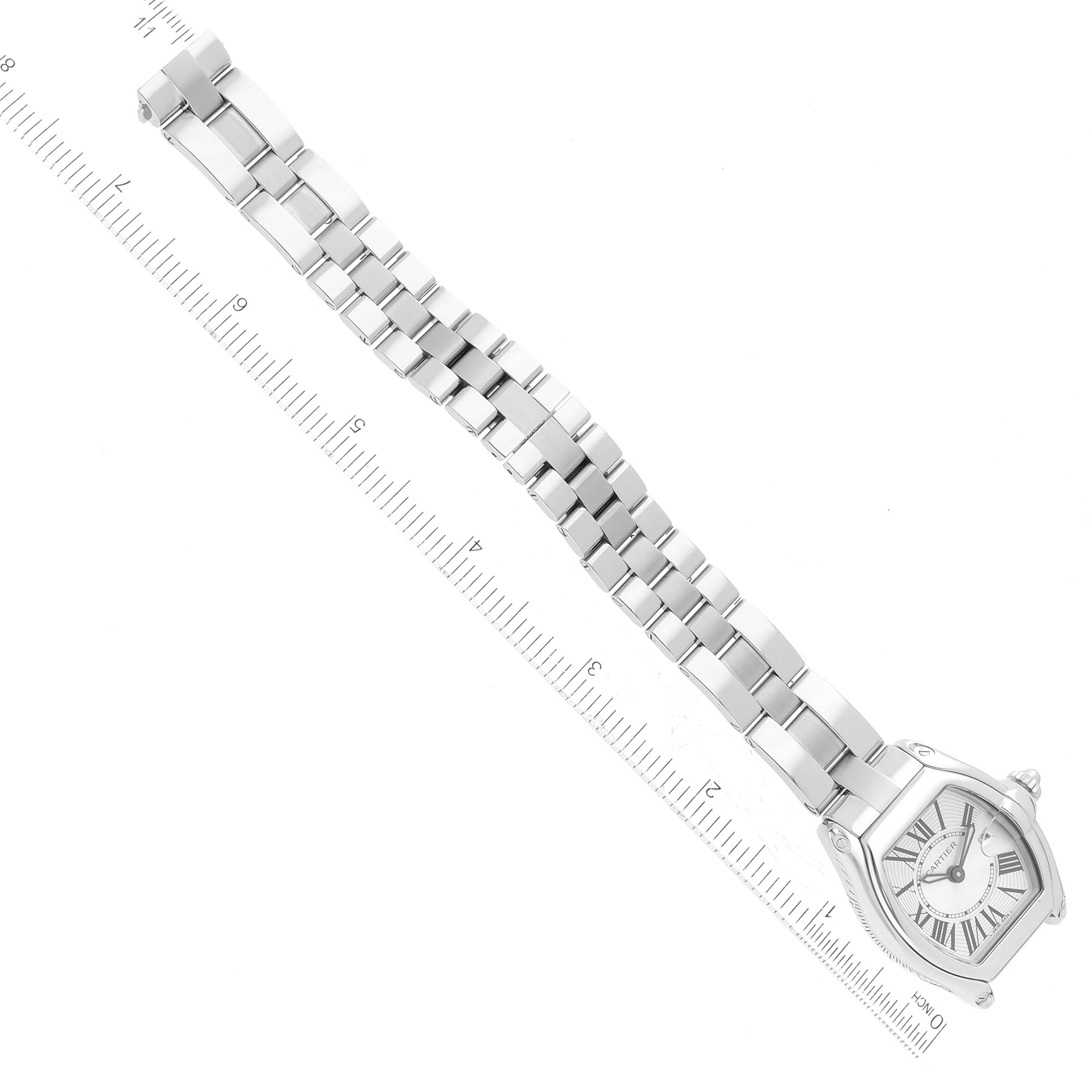 This image shows the full length and front view of the Cartier Roadster W62016V3 Women
s Stainless Steel Silver Dial W62016V3 Women
s Stainless Steel Silver Dial watch with a metal bracelet against a ruler for scale.