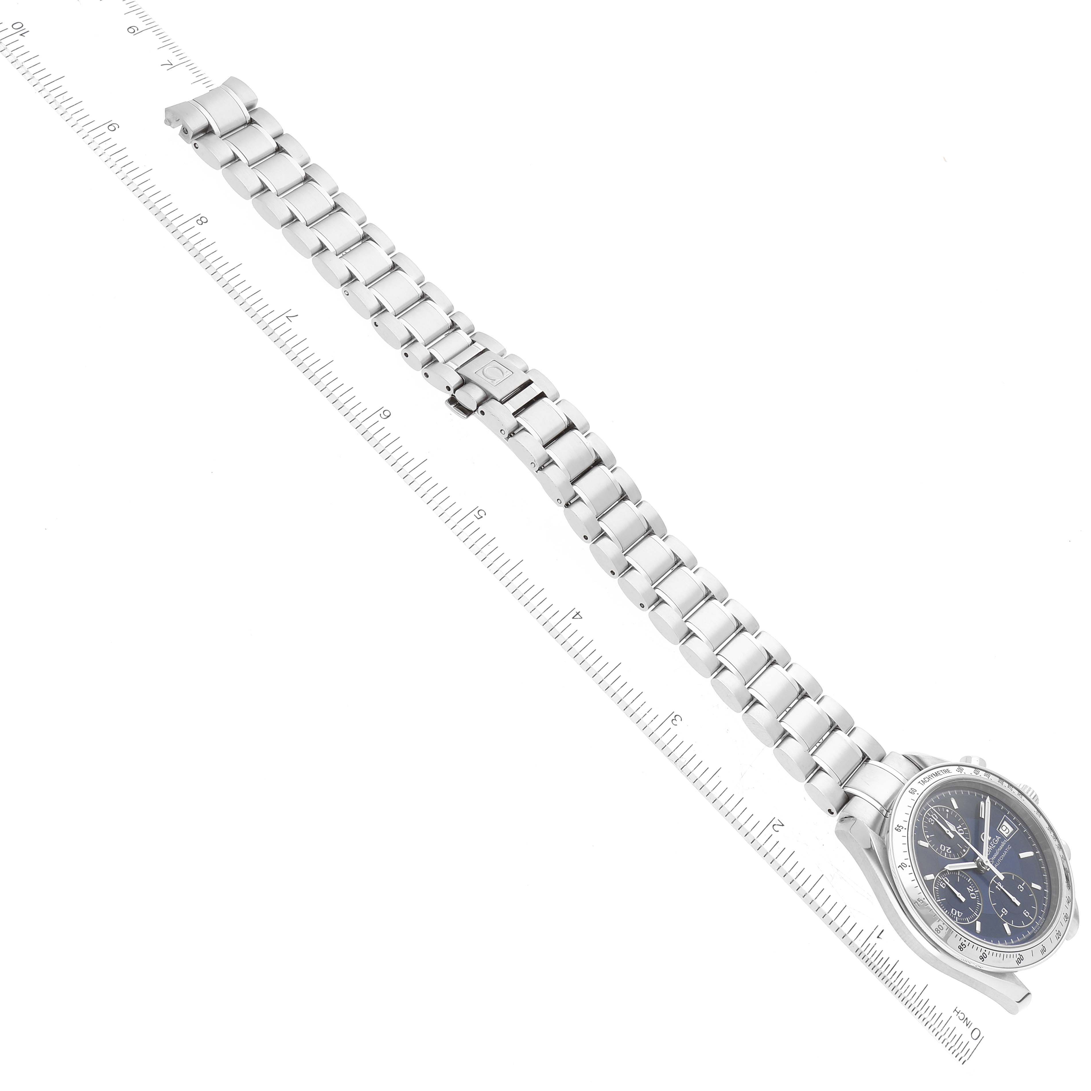 The image shows an Omega Speedmaster 3513.80.00 Men
s Stainless Steel Blue Dial 3513.80.00 Men
s Stainless Steel Blue Dial watch from a top-down angle, highlighting the face and metal bracelet with a ruler for scale.