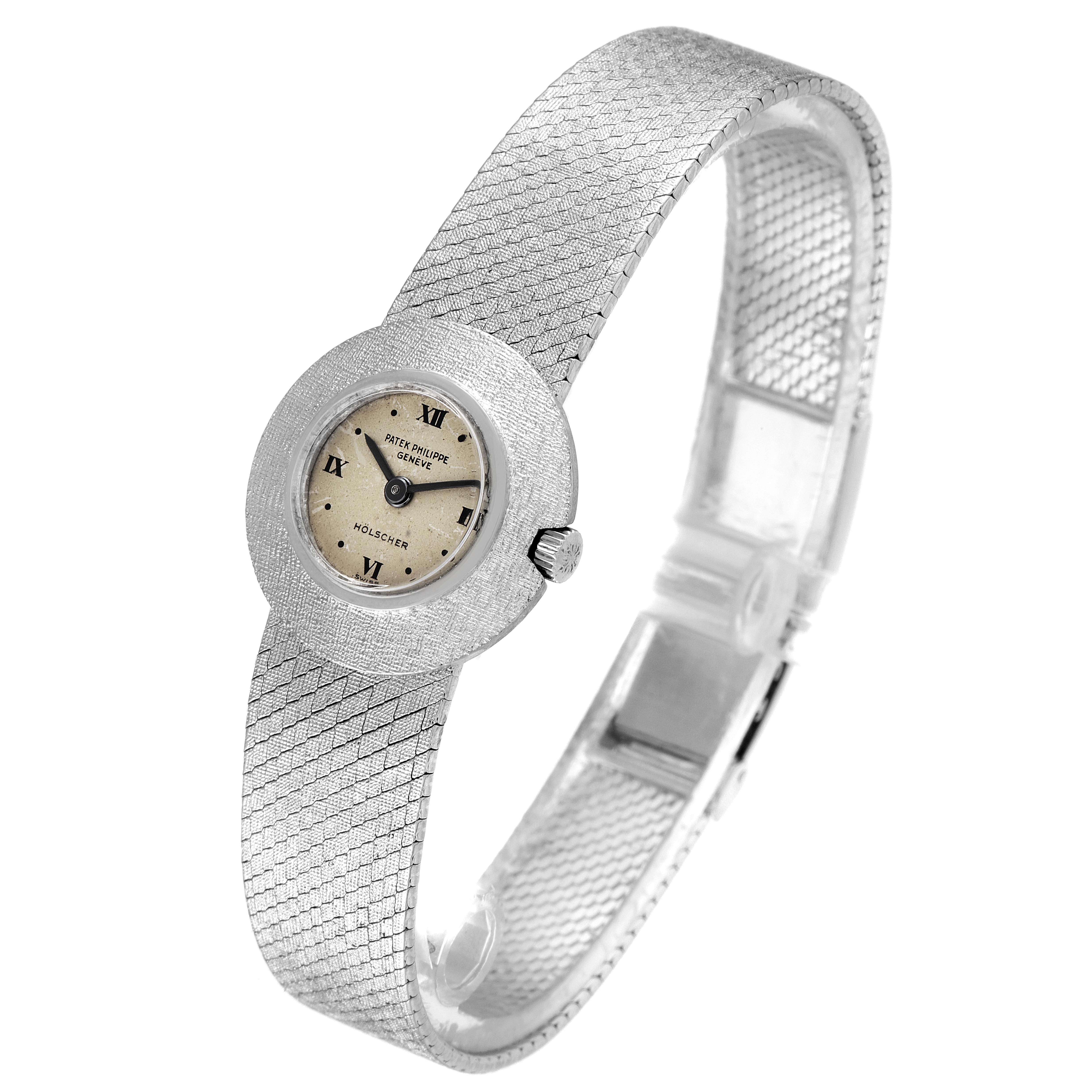 This image shows a Patek Philippe Calatrava 3344 Women's White Gold Silver Dial 3344 Women's White Gold Silver Dial watch with a textured bracelet and a small round face, viewed from an angled side perspective.