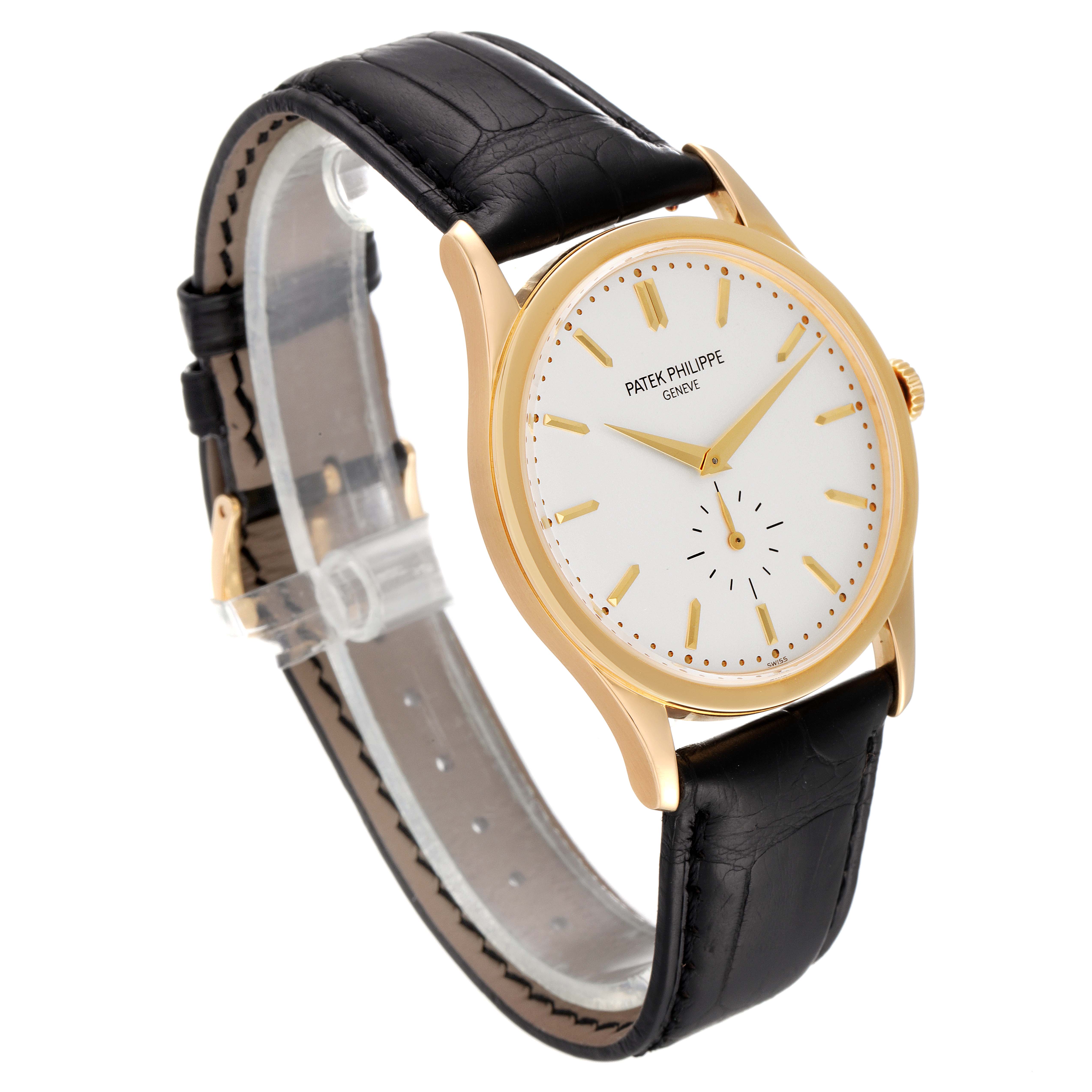 The image shows a Patek Philippe Calatrava 5196J Men's Yellow Gold Silver Dial 5196J Men's Yellow Gold Silver Dial watch at an angled view, highlighting its face, casing, and leather strap.