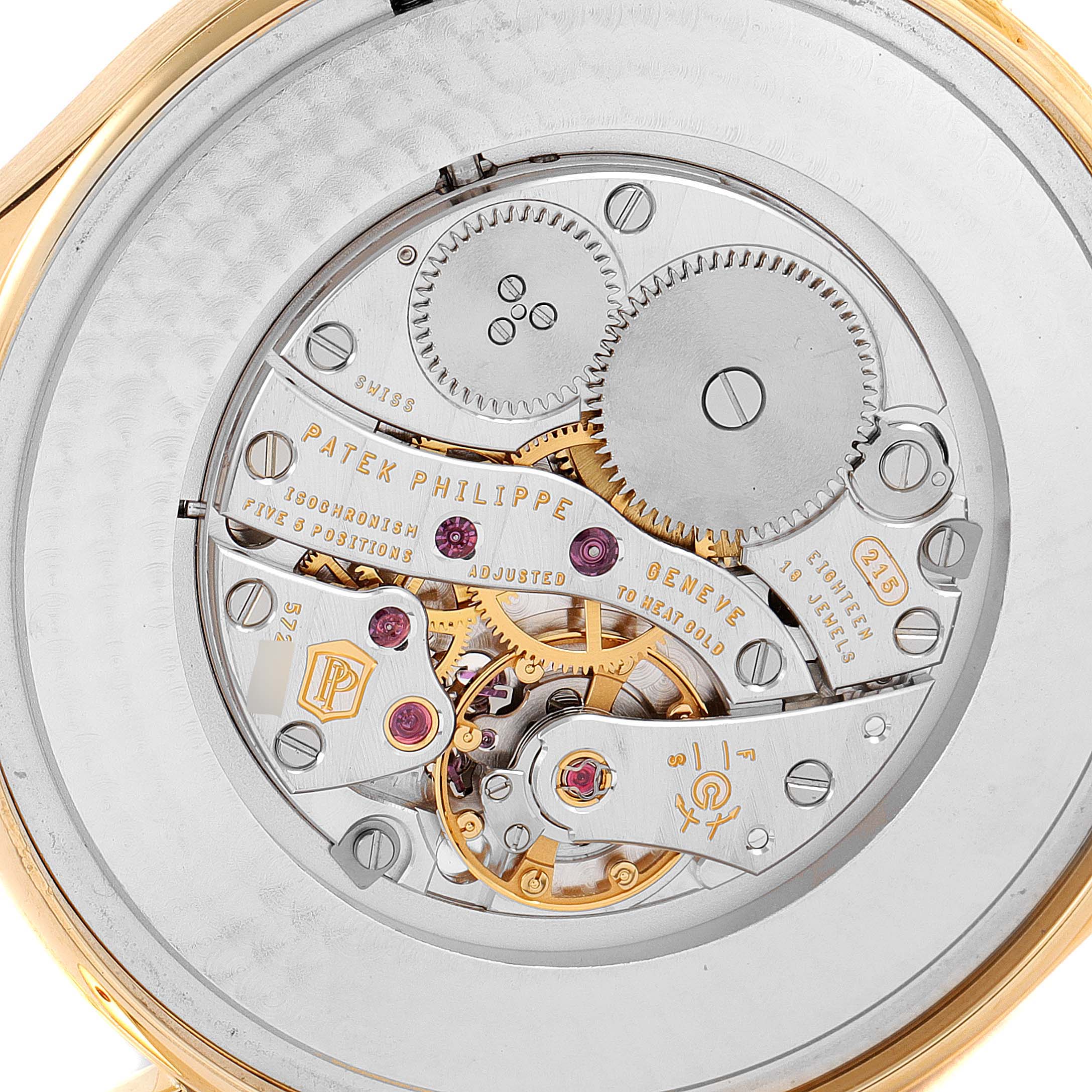 The image shows the intricate movement and mechanism of a Patek Philippe Calatrava 5196J Men's Yellow Gold Silver Dial 5196J Men's Yellow Gold Silver Dial watch from a rear angle.