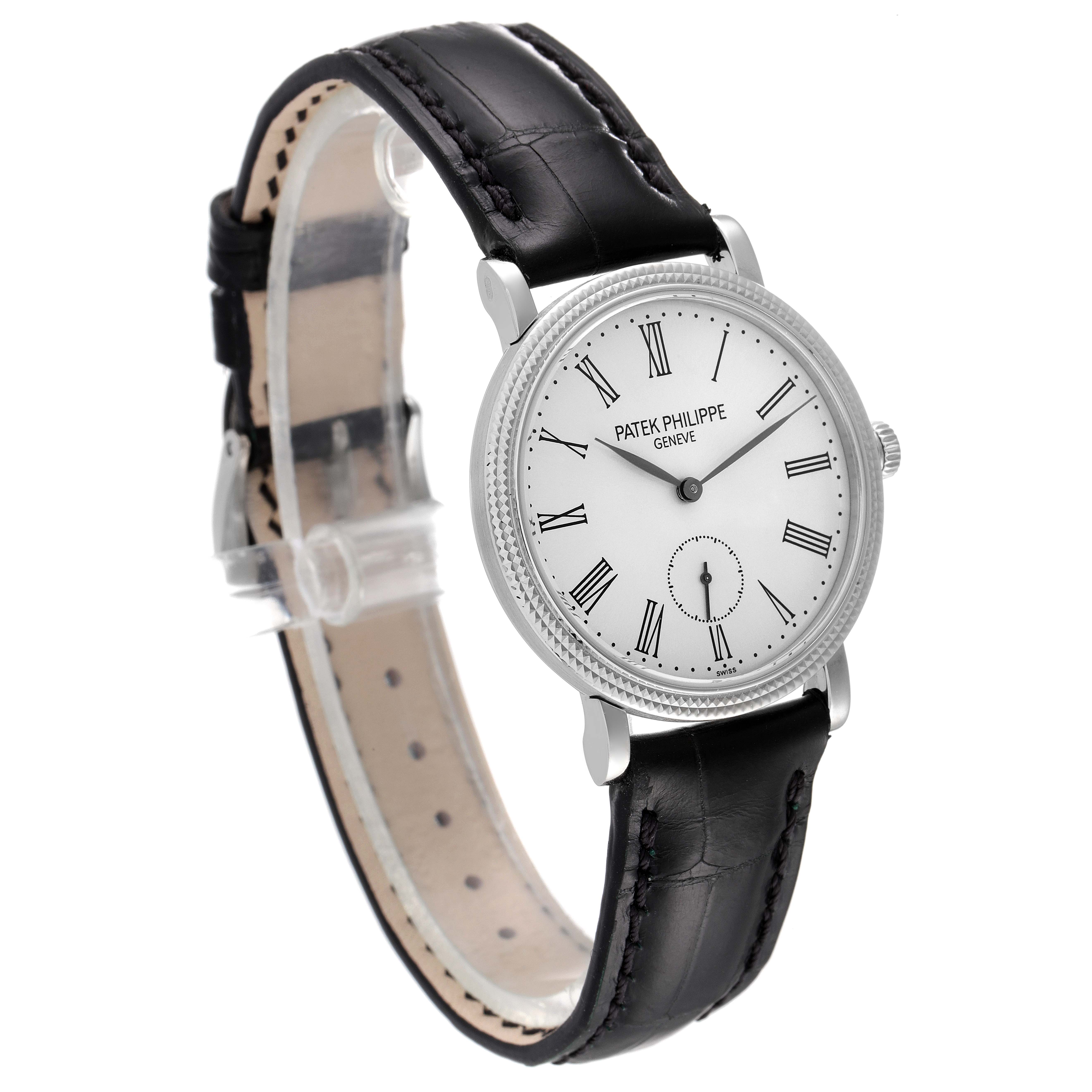 The image shows a Patek Philippe Calatrava 7119G Men's White Gold Silver Dial 7119G Men's White Gold Silver Dial watch at a slight side angle, highlighting its face, bezel, and leather strap.
