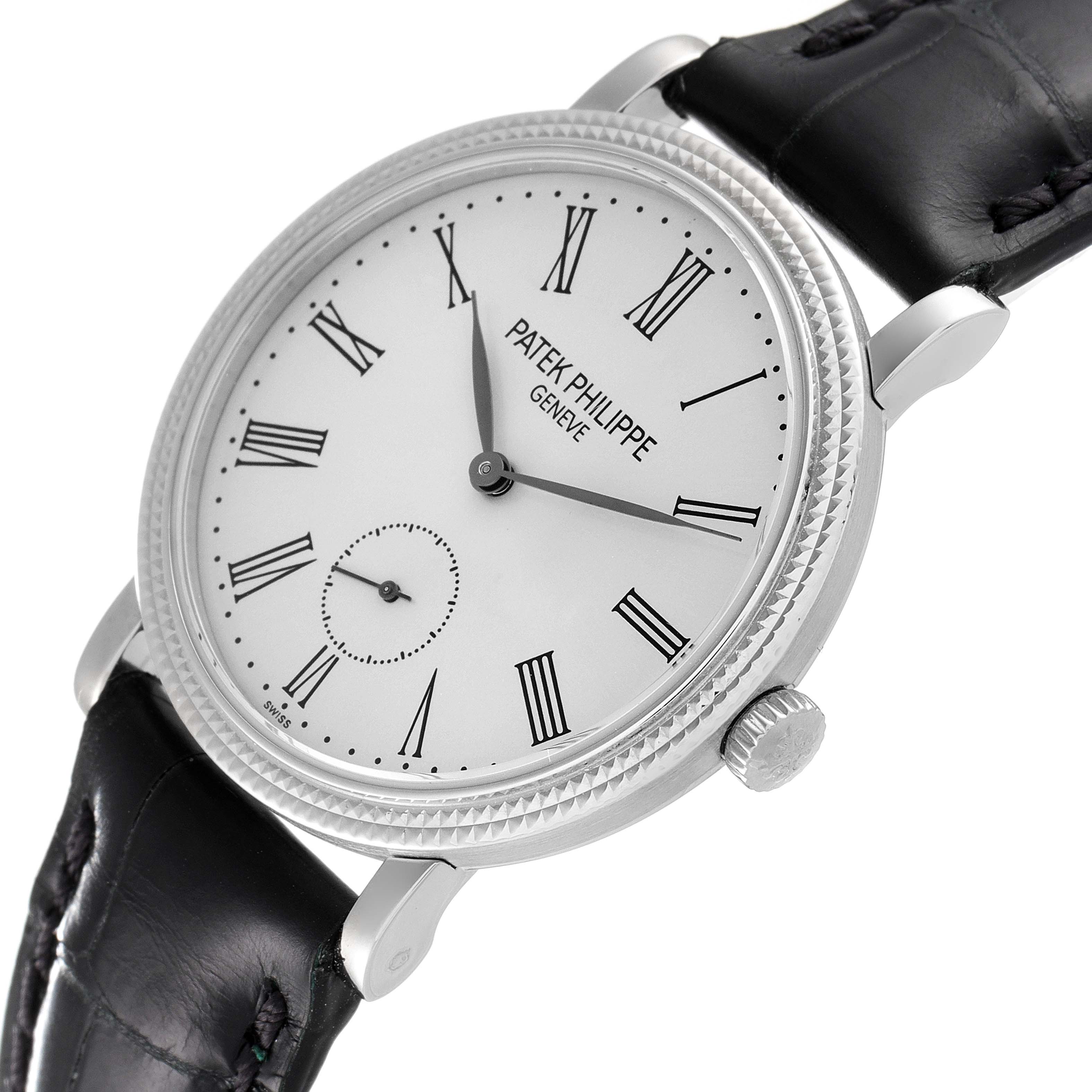 This image shows a close-up of the Patek Philippe Calatrava 7119G Men's White Gold Silver Dial 7119G Men's White Gold Silver Dial watch face, bezel, crown, and leather strap at an angled view.