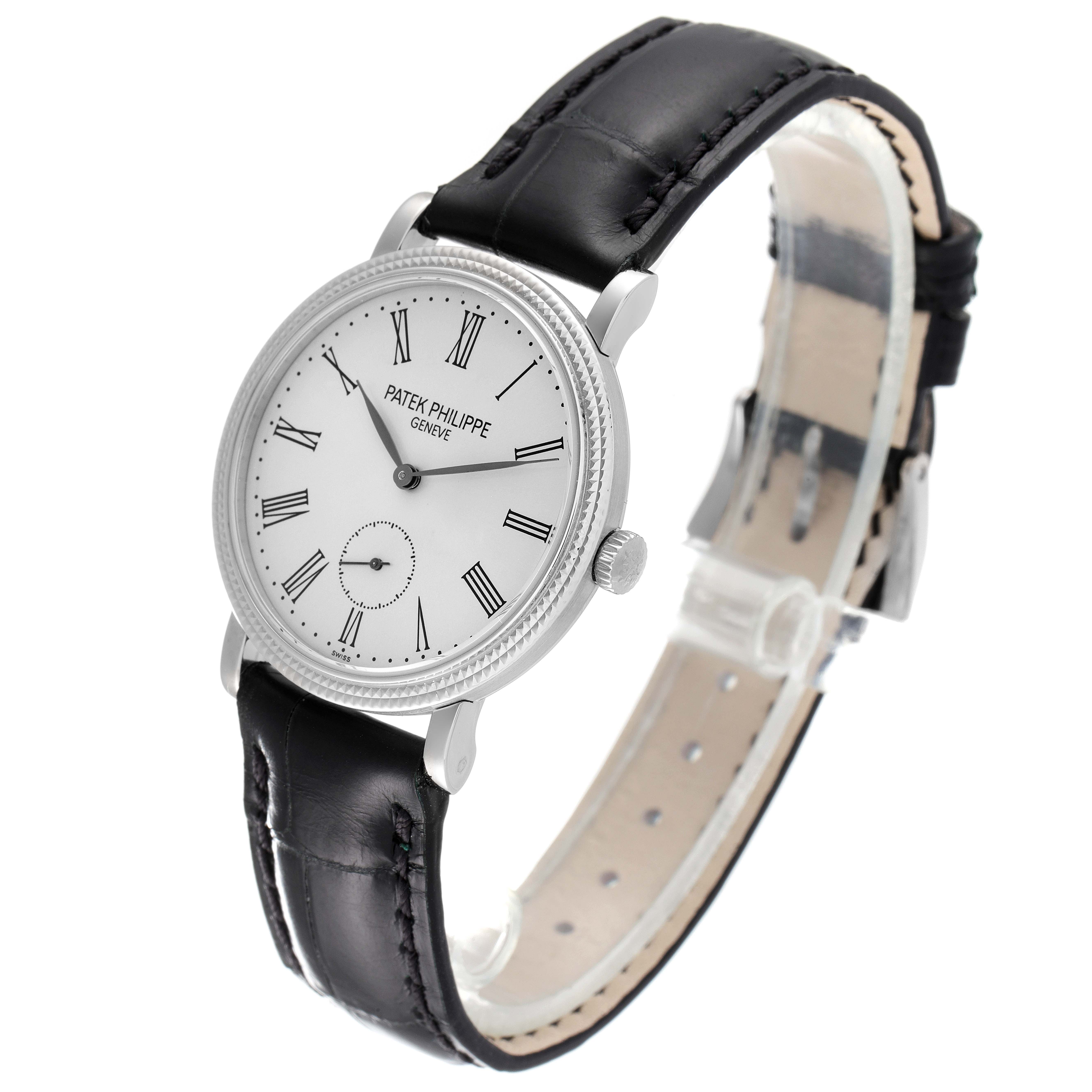 The image shows a Patek Philippe Calatrava 7119G Men's White Gold Silver Dial 7119G Men's White Gold Silver Dial watch at an angle, highlighting the dial, crown, and leather strap.