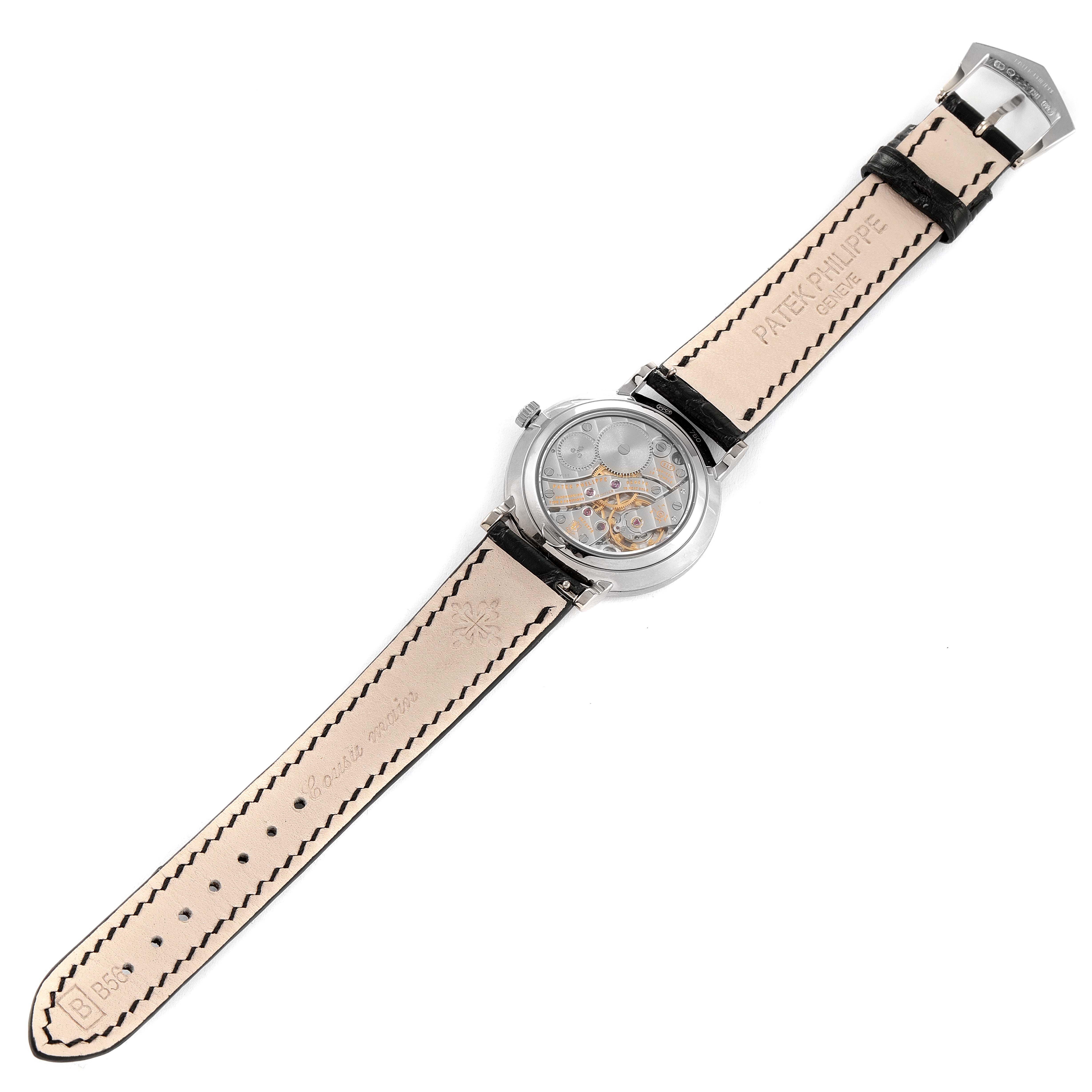 The image shows the back view of the Patek Philippe Calatrava 7119G Women's White Gold White Dial 7119G Women's White Gold White Dial watch, displaying its movement and leather strap.