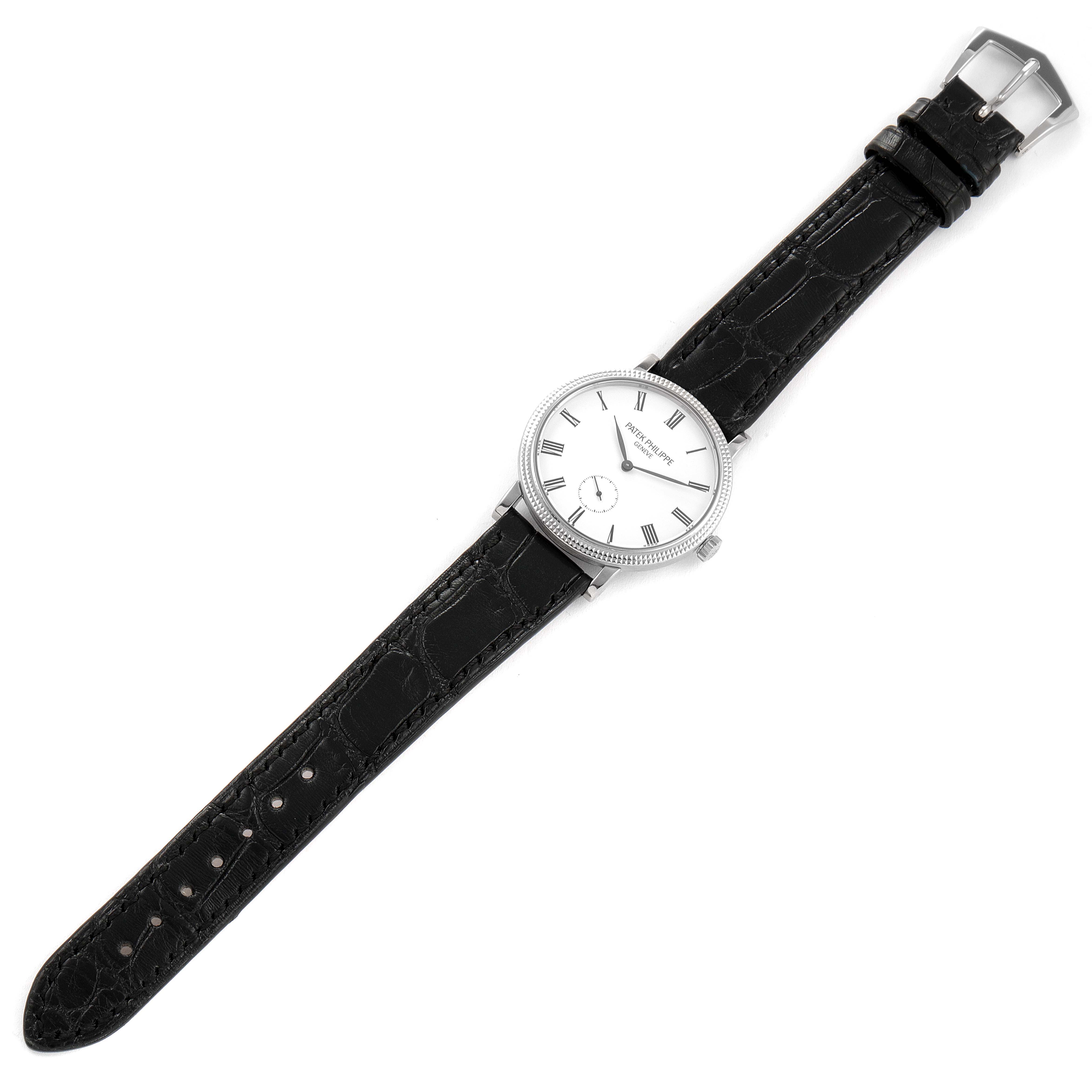 This image of a Patek Philippe Calatrava 7119G Women's White Gold White Dial 7119G Women's White Gold White Dial watch shows a top-down view displaying the dial, case, crown, and full leather strap with buckle.