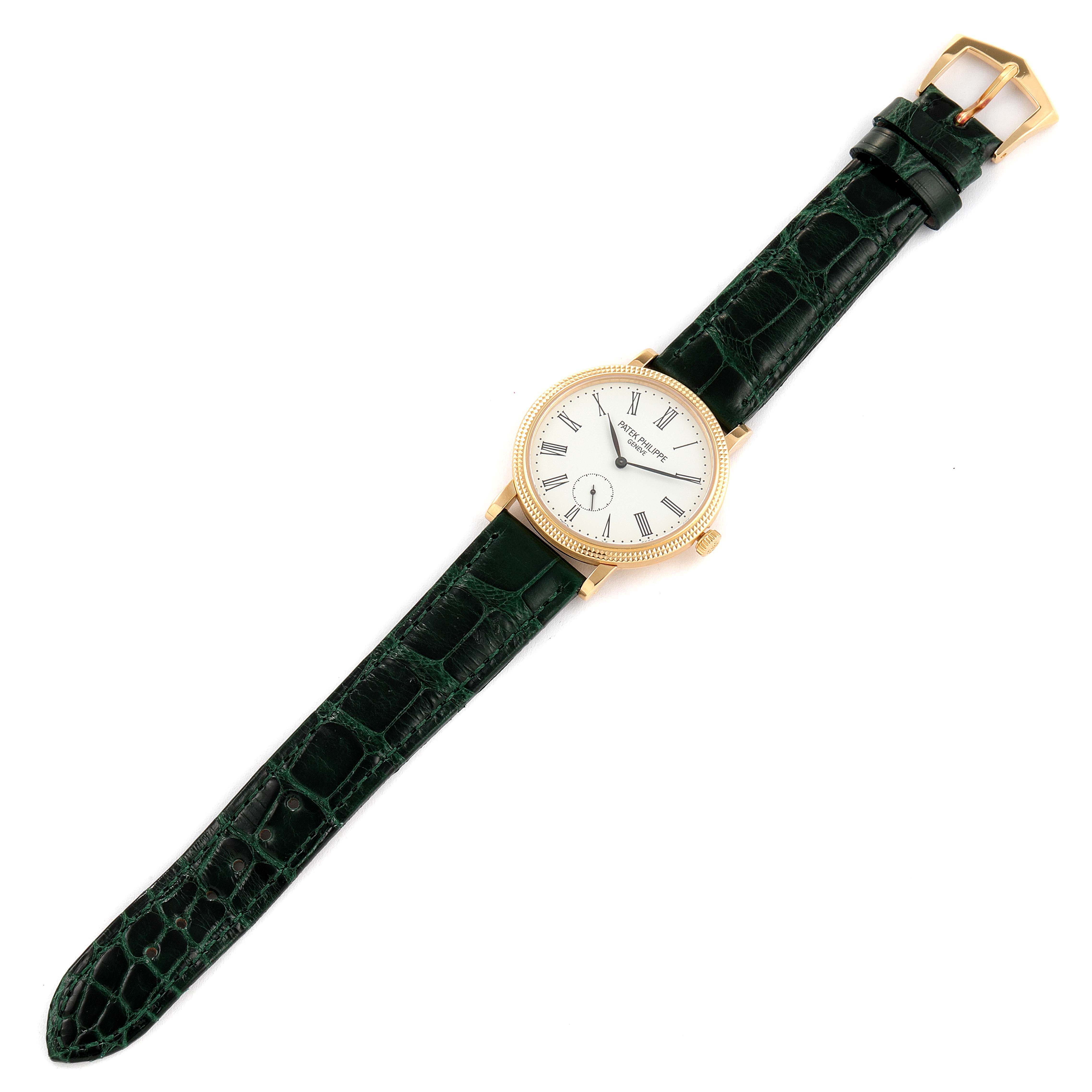 The image shows a top view of a Patek Philippe Calatrava 7119J Women's Yellow Gold White Dial 7119J Women's Yellow Gold White Dial watch with a green crocodile leather strap and a gold case.