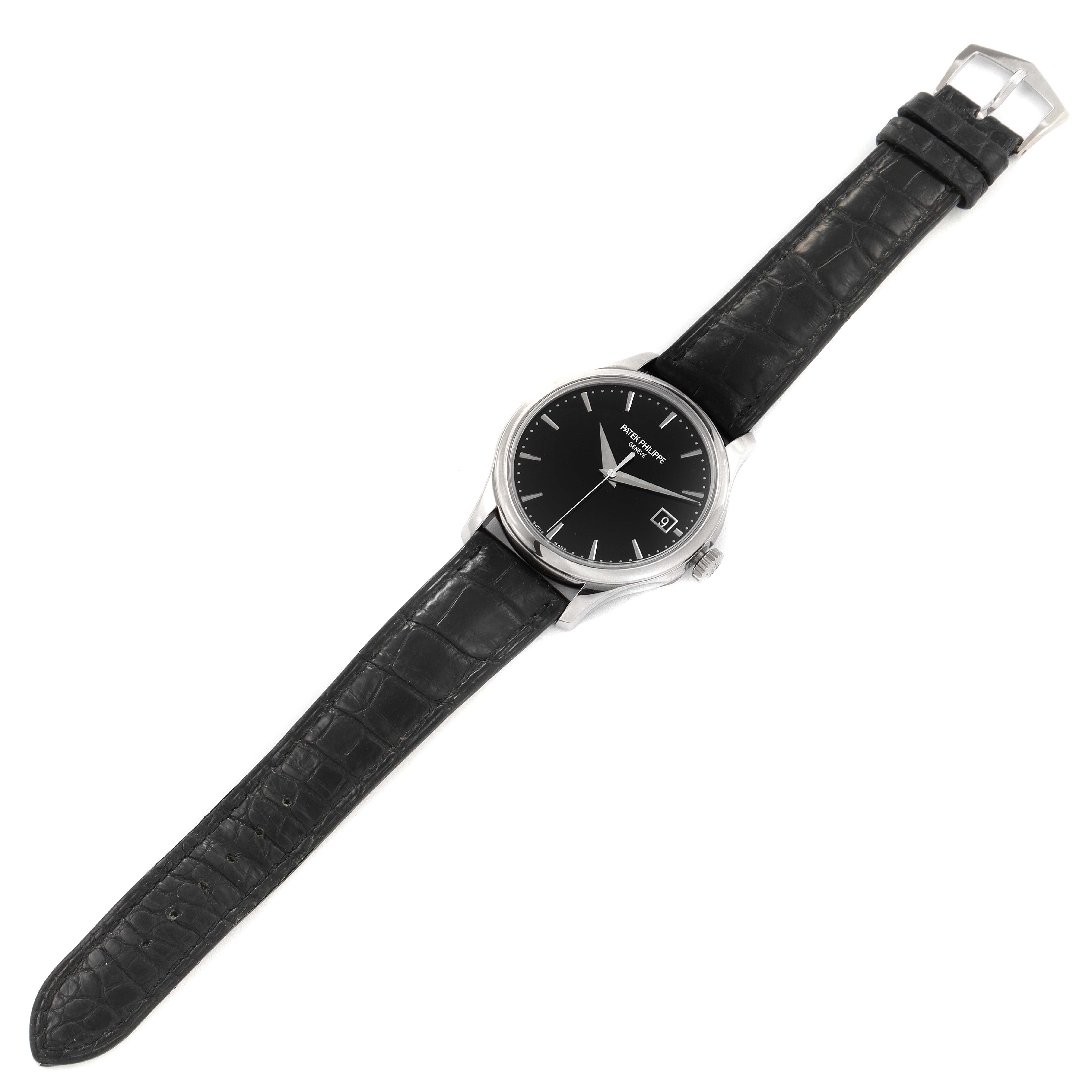 The image shows a top-down view of a Patek Philippe Calatrava 5227G Men's White Gold Black Dial 5227G Men's White Gold Black Dial watch, displaying the black dial and black leather strap.
