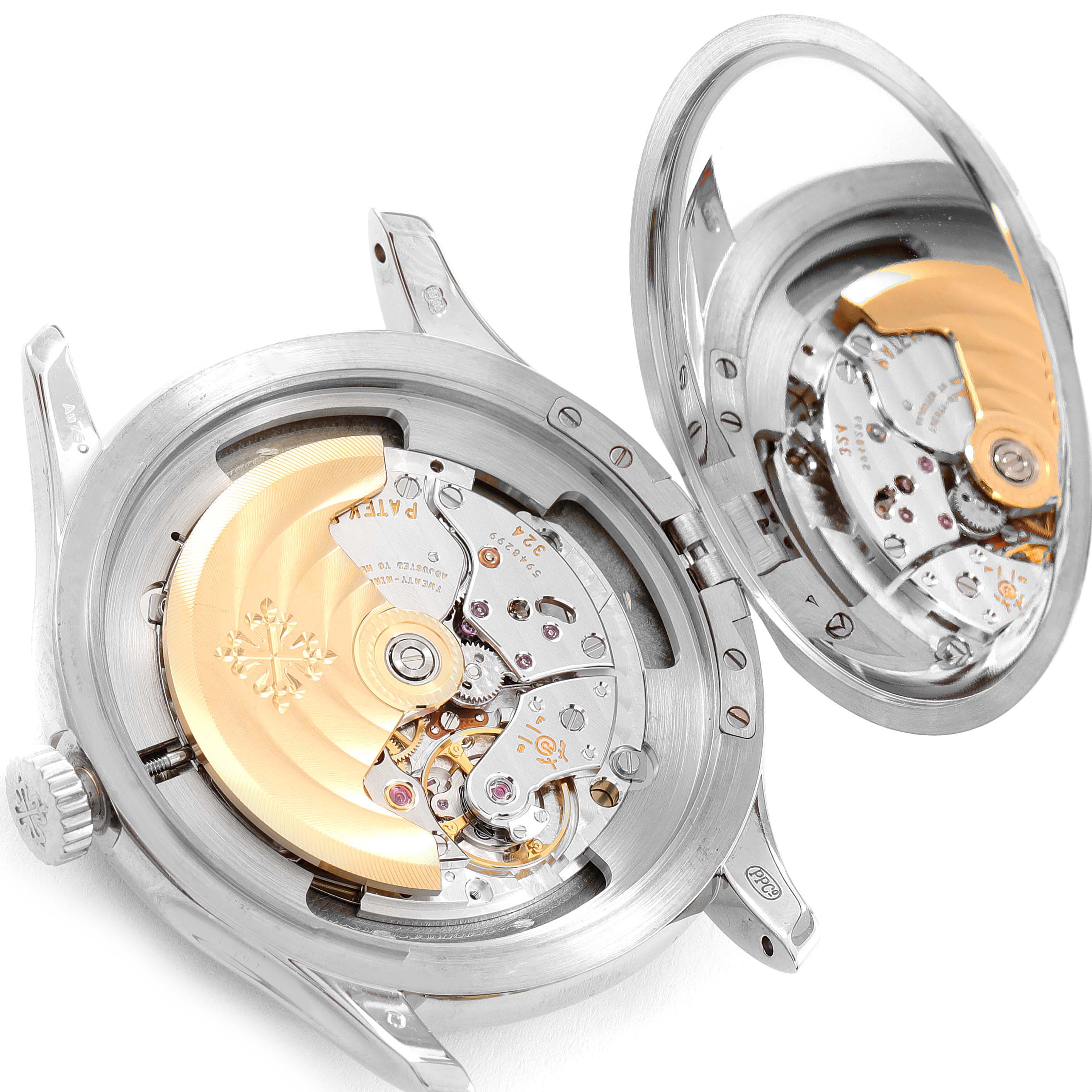 The image shows the opened case back of a Patek Philippe Calatrava 5227G Men's White Gold Black Dial 5227G Men's White Gold Black Dial watch, revealing its intricate movement and rotor.