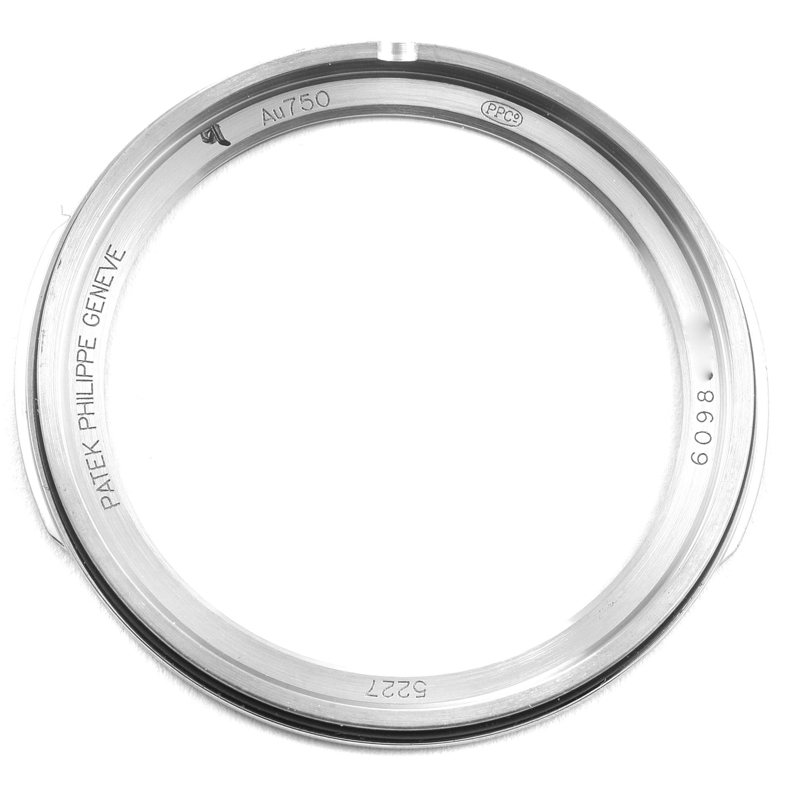 This image shows a close-up of a Patek Philippe Calatrava 5227G Men's White Gold Black Dial 5227G Men's White Gold Black Dial watch case, with inscriptions and serial markings visible.