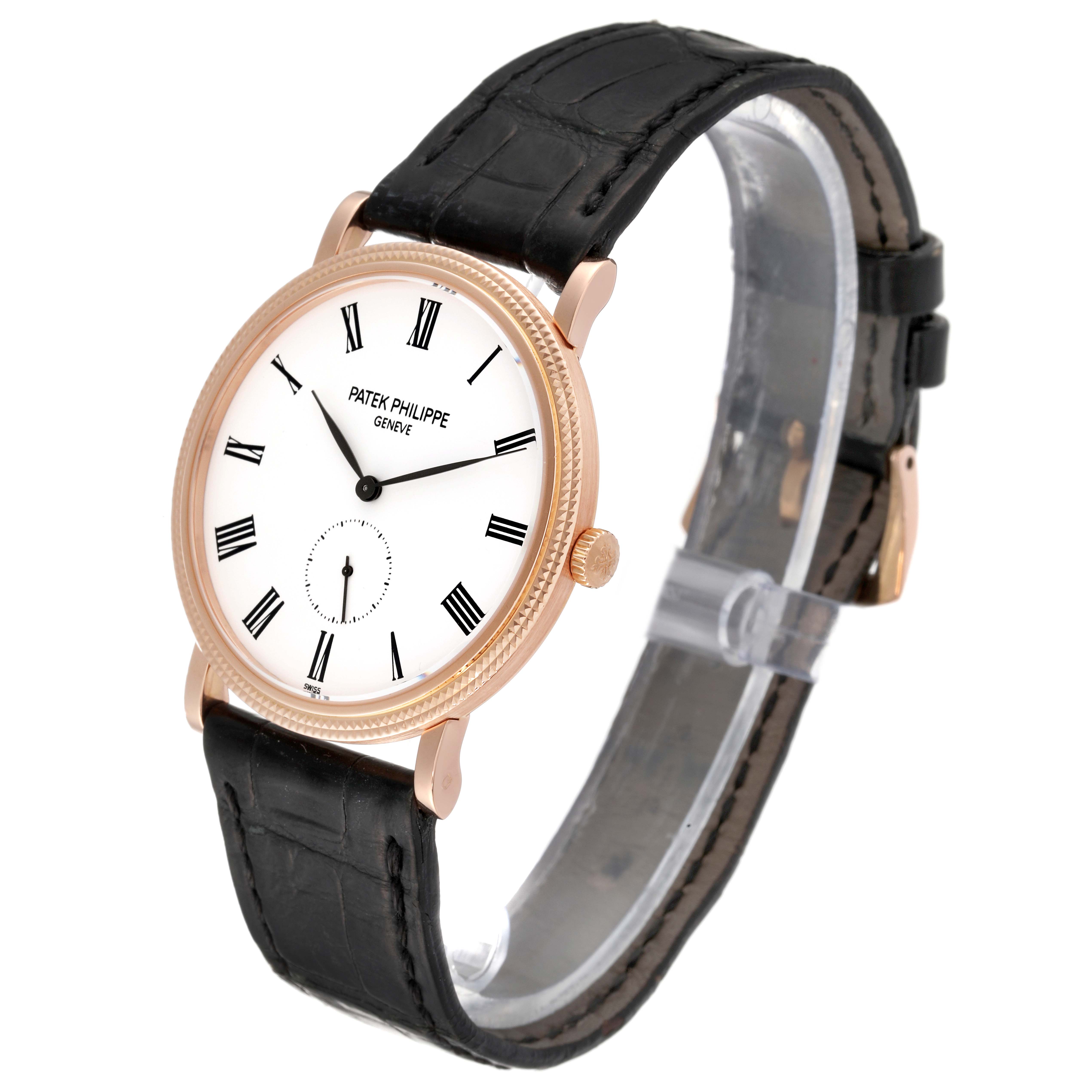 The image shows a Patek Philippe Calatrava 5119R Men
s Rose Gold White Dial 5119R Men
s Rose Gold White Dial watch at a three-quarter angle, highlighting its face, black leather strap, and gold bezel.