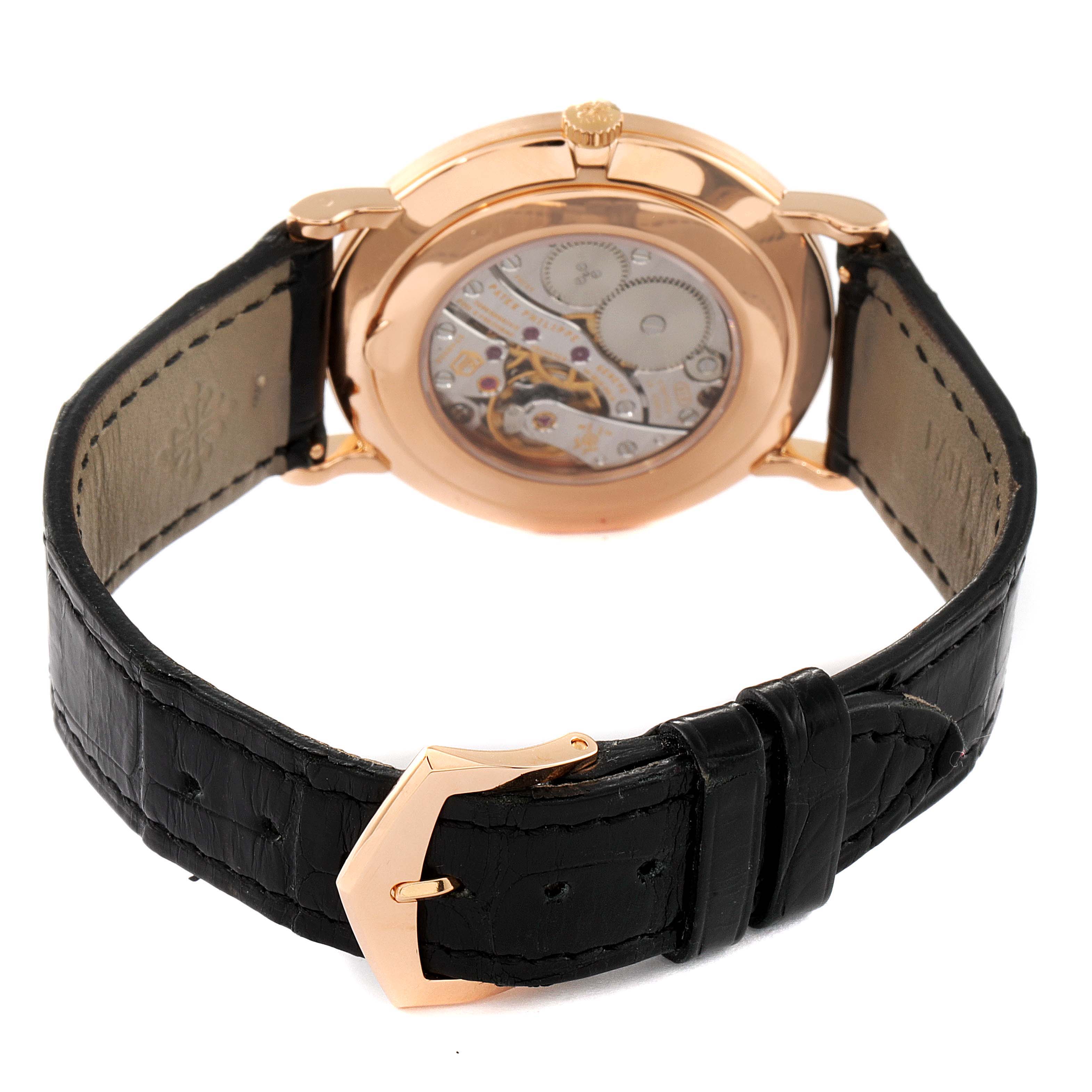 The image shows the rear view of a Patek Philippe Calatrava 5119R Men's Rose Gold White Dial 5119R Men's Rose Gold White Dial watch, highlighting its movement and black leather strap.