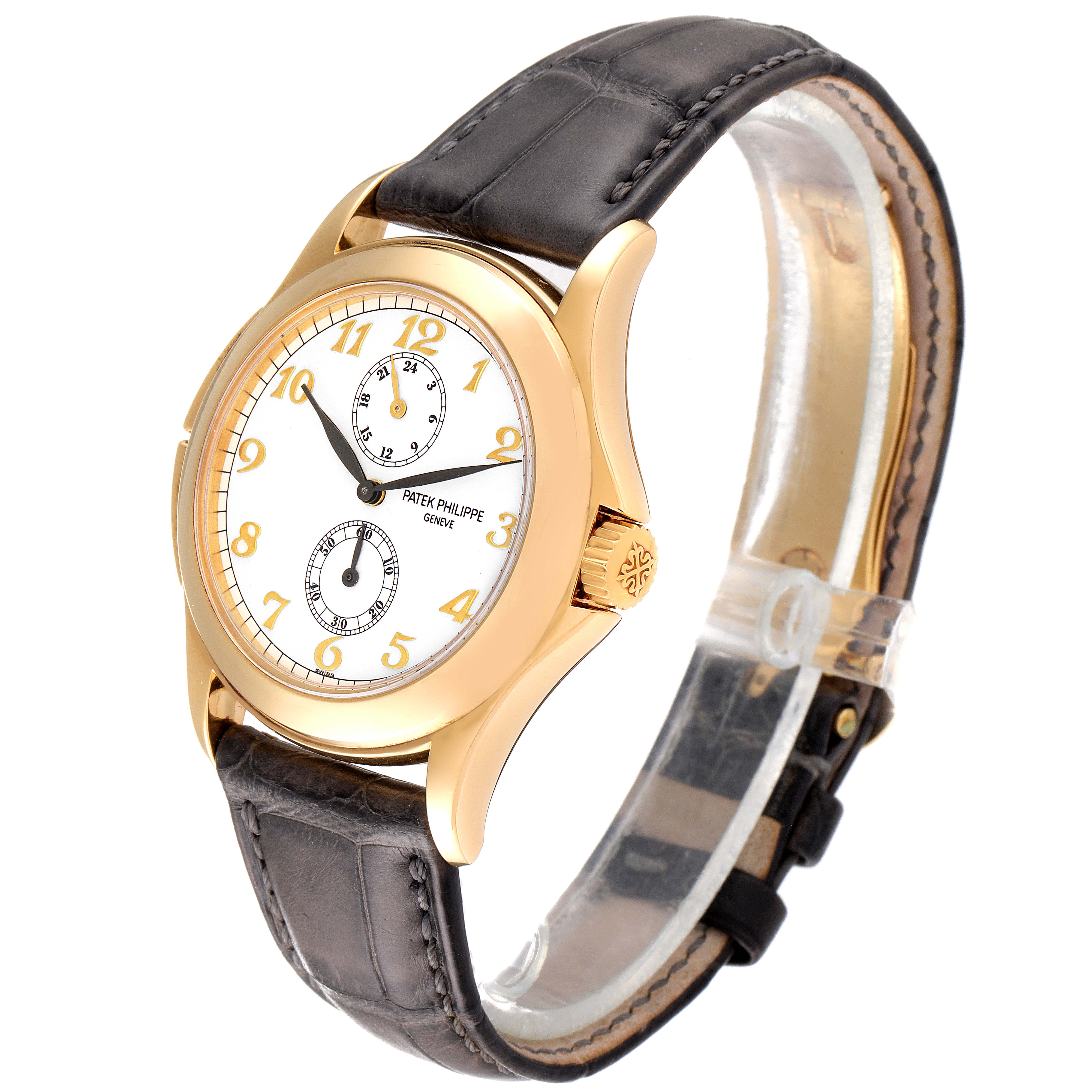 This image showcases the Patek Philippe Calatrava 5134J Men's Yellow Gold White Dial 5134J Men's Yellow Gold White Dial model from an angled side view, displaying the face, crown, and leather strap prominently.