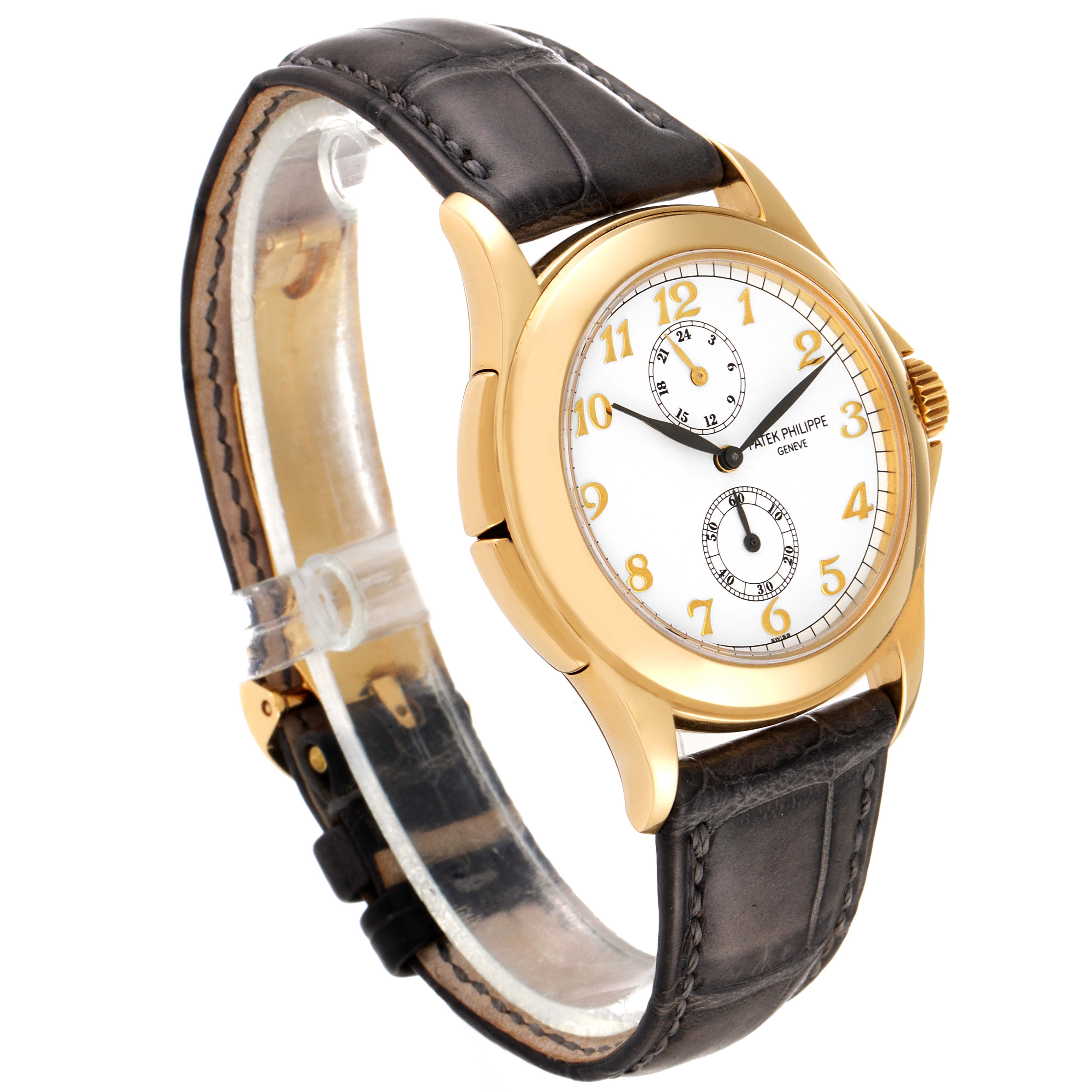This image shows a Patek Philippe Calatrava 5134J Men's Yellow Gold White Dial 5134J Men's Yellow Gold White Dial watch at a three-quarter angle, highlighting its dial, bezel, case, and leather strap.