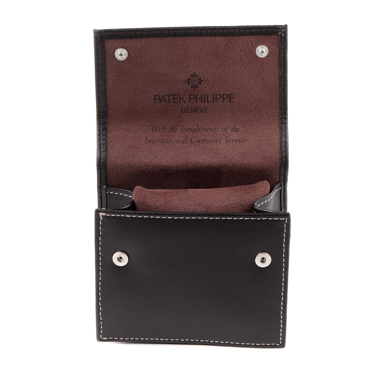 This image shows a Patek Philippe Calatrava 5134J Men's Yellow Gold White Dial 5134J Men's Yellow Gold White Dial leather carrying case, open to reveal its interior.