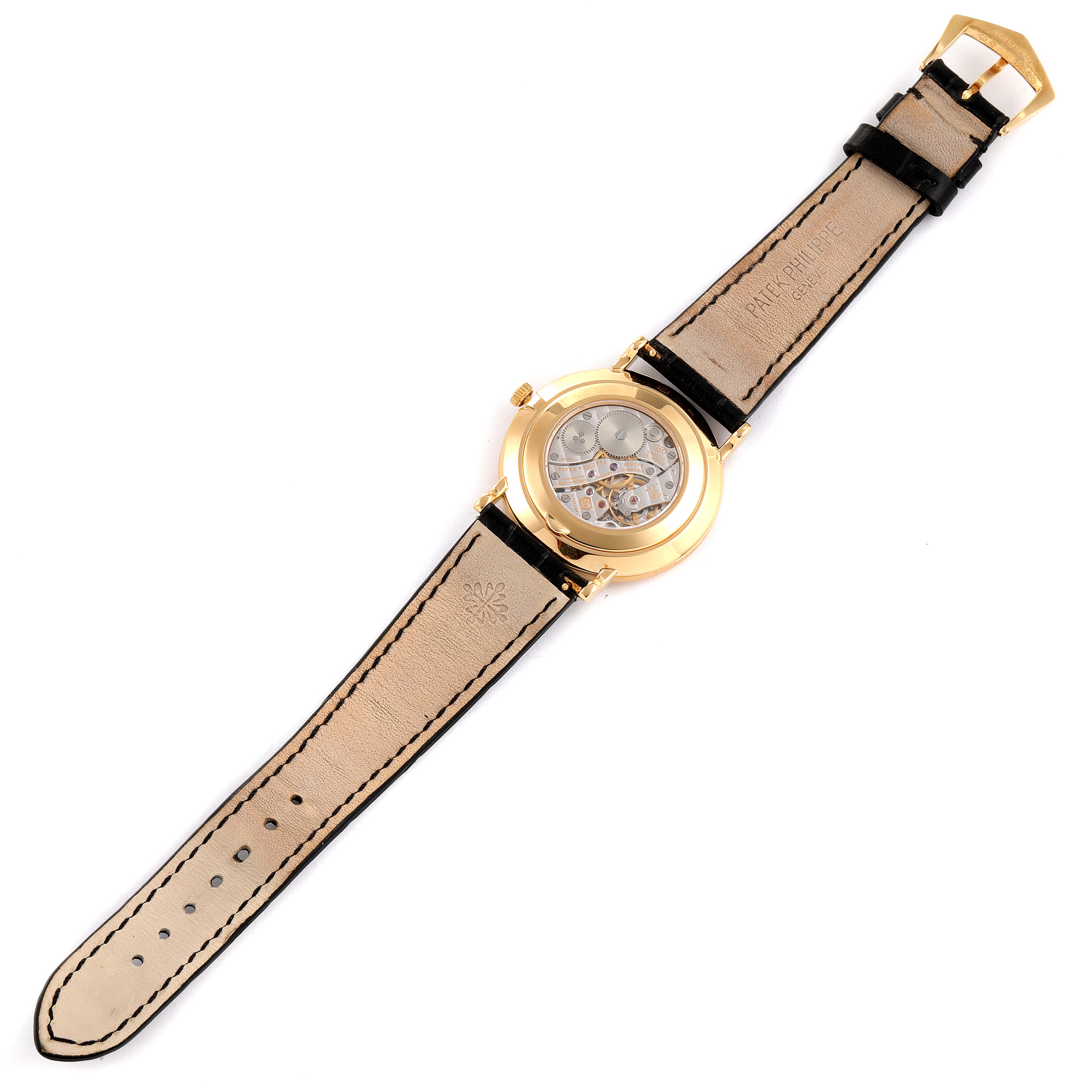 This is a Patek Philippe Calatrava 5119J Men
s Yellow Gold White Dial 5119J Men
s Yellow Gold White Dial watch shown from the back, highlighting the movement and the leather strap.