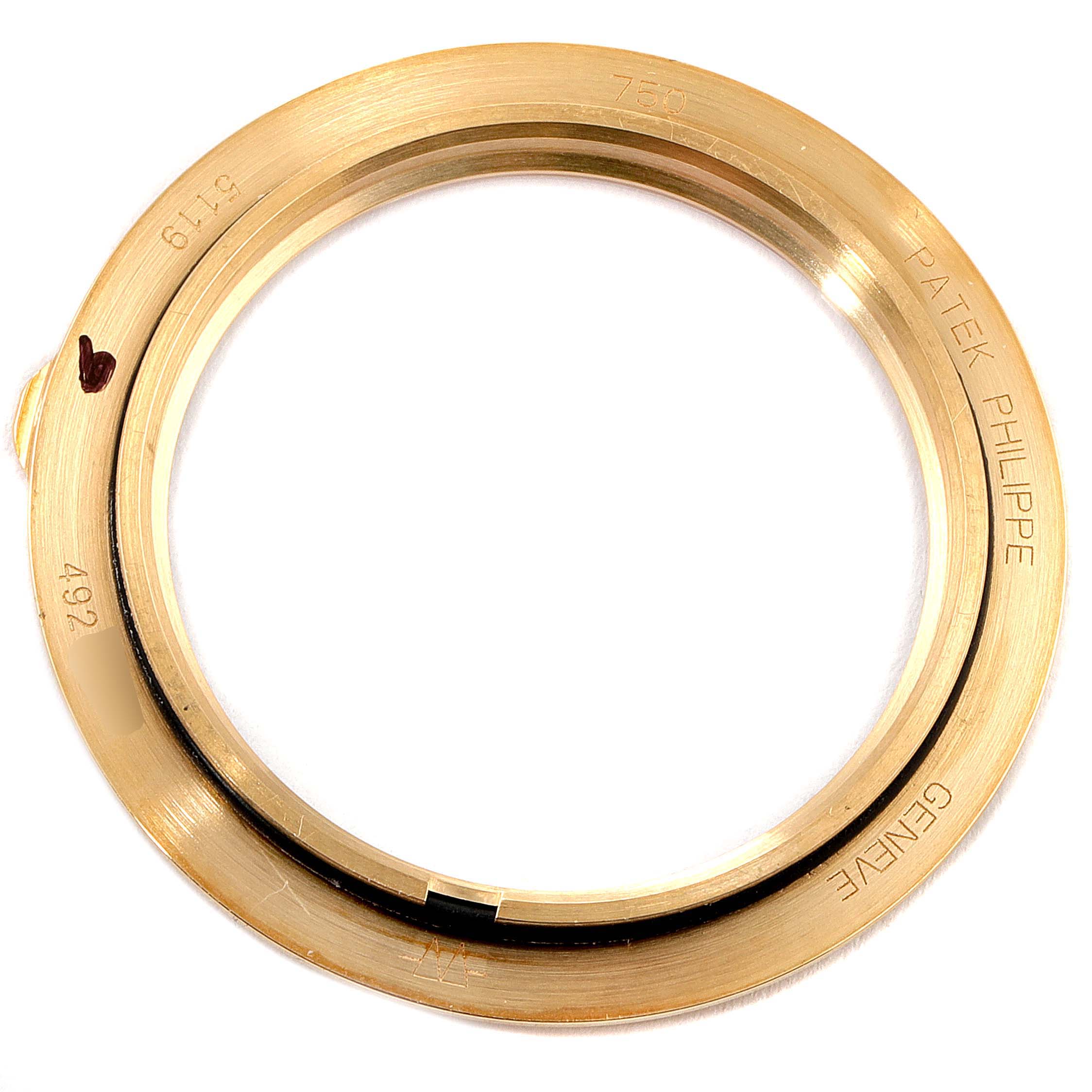 The image shows a close-up view of a gold bezel for a Patek Philippe Calatrava 5119J Men
s Yellow Gold White Dial 5119J Men
s Yellow Gold White Dial watch.