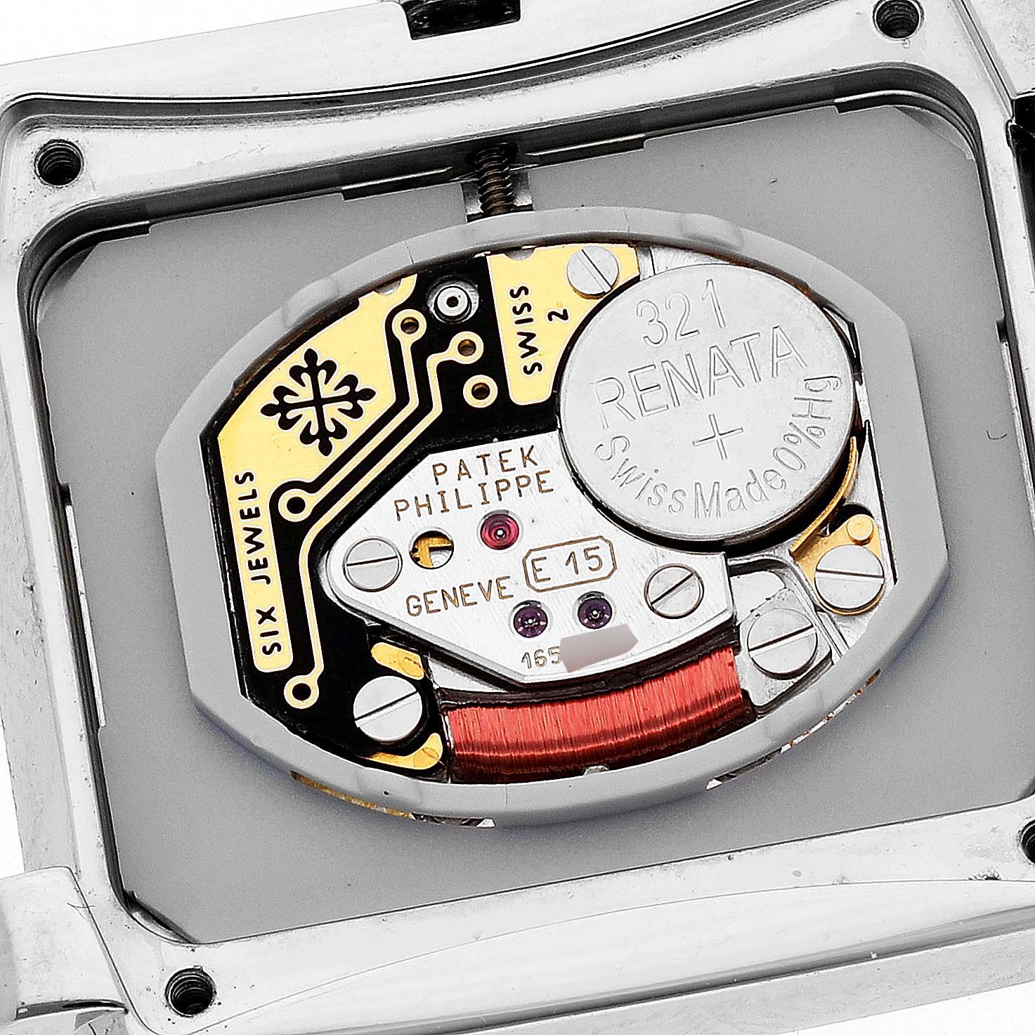 The image shows the inner mechanism of the Twenty-4 model by Patek Philippe, including the battery and circuit.