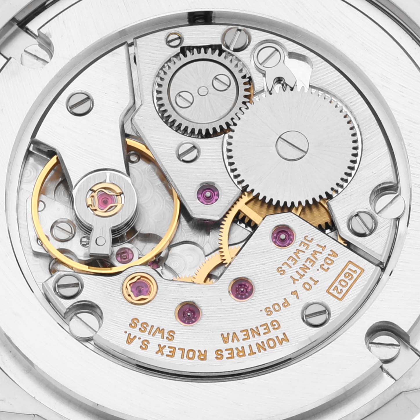 The image shows the intricate inner mechanical details of a Rolex Cellini 5116/9 Men
s White Gold Silver Dial 5116/9 Men
s White Gold Silver Dial watch, highlighting gears, cogs, and jewels.