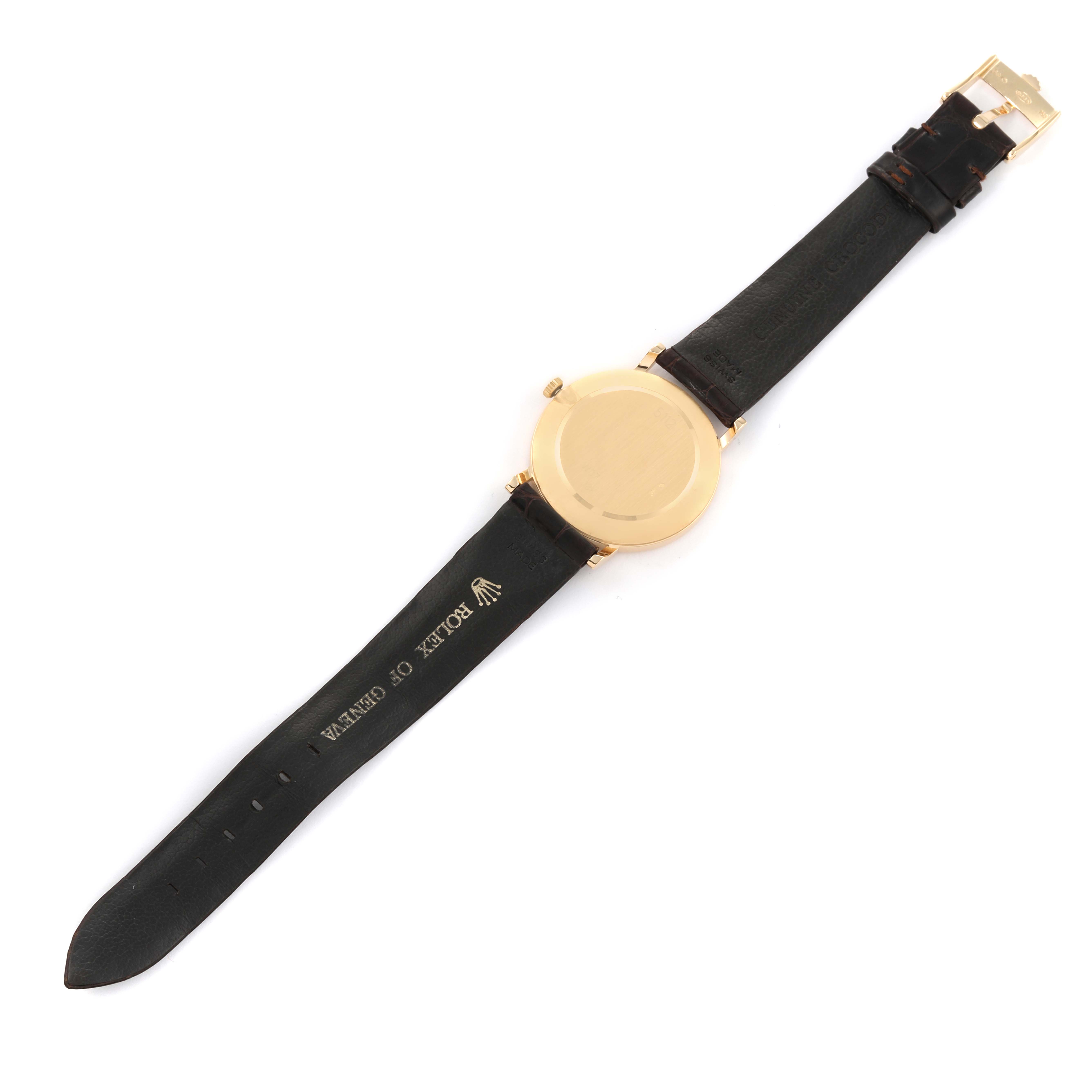 The image shows the back view of a Rolex Cellini 5112/8 Men's Yellow Gold Champagne Dial 5112/8 Men's Yellow Gold Champagne Dial watch, highlighting its gold case and black leather strap.