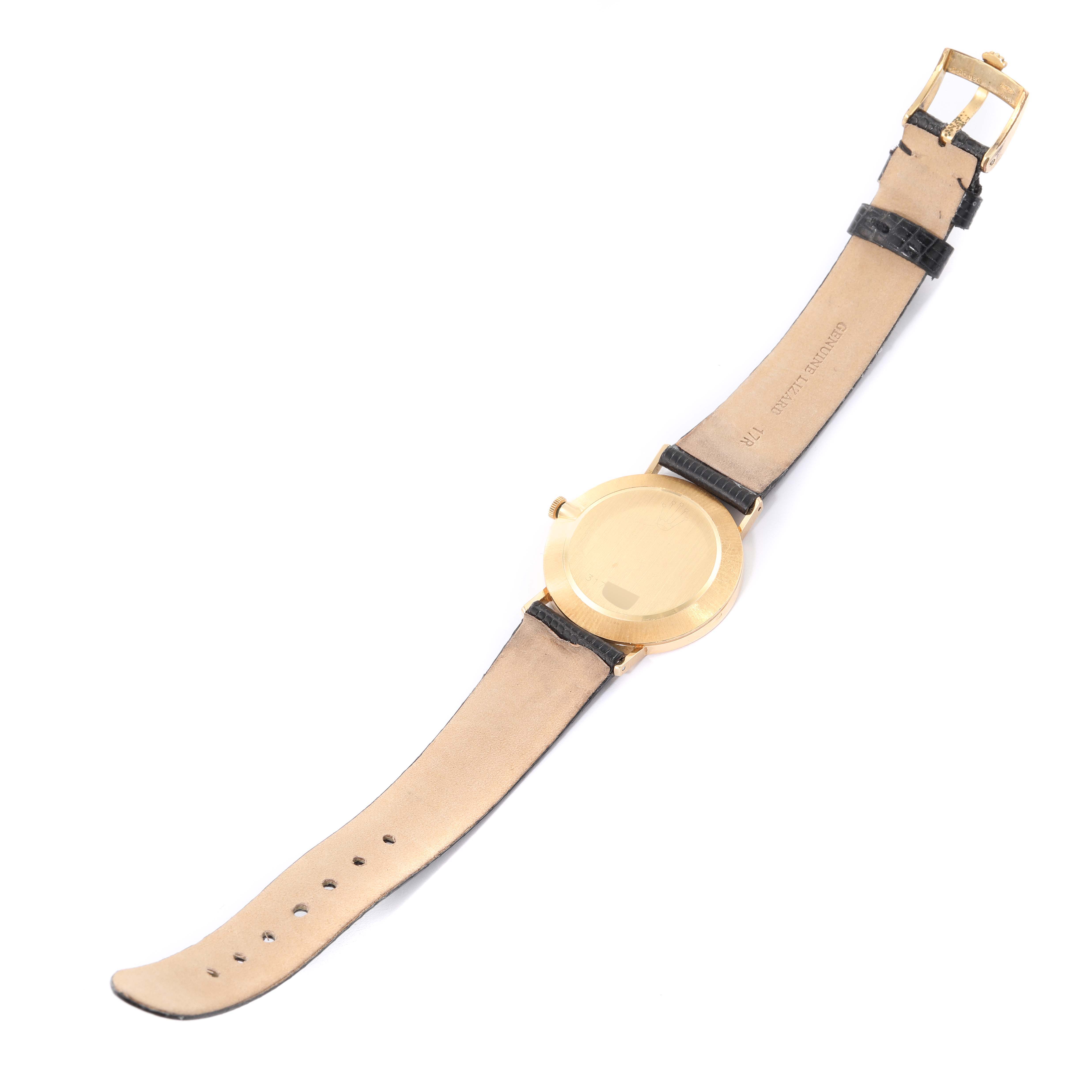 The image shows the back view of a Rolex Vintage Collection 4112/8 Men's Yellow Gold Silver Dial 4112/8 Men's Yellow Gold Silver Dial watch, displaying its gold case and leather strap.