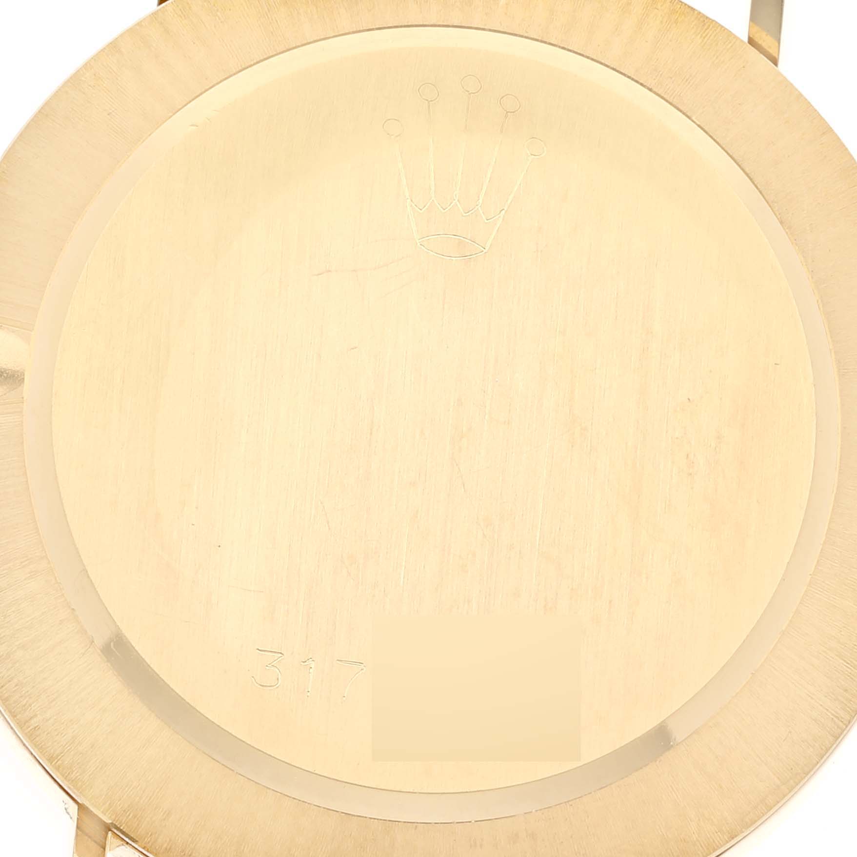 The image shows the back case of a Vintage Collection model by Rolex, displaying the brand's engraved crown logo.