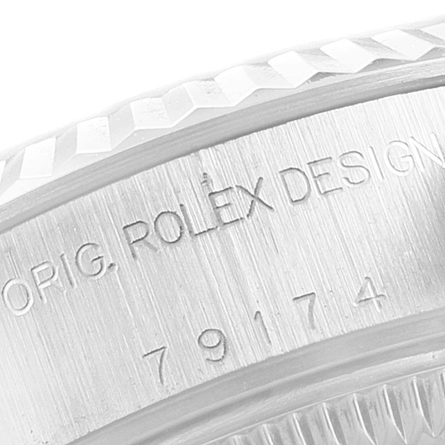 The image shows a close-up of the engraved bezel and case edge of a Rolex Datejust 79174 Women
s Stainless Steel White Dial 79174 Women
s Stainless Steel White Dial watch.