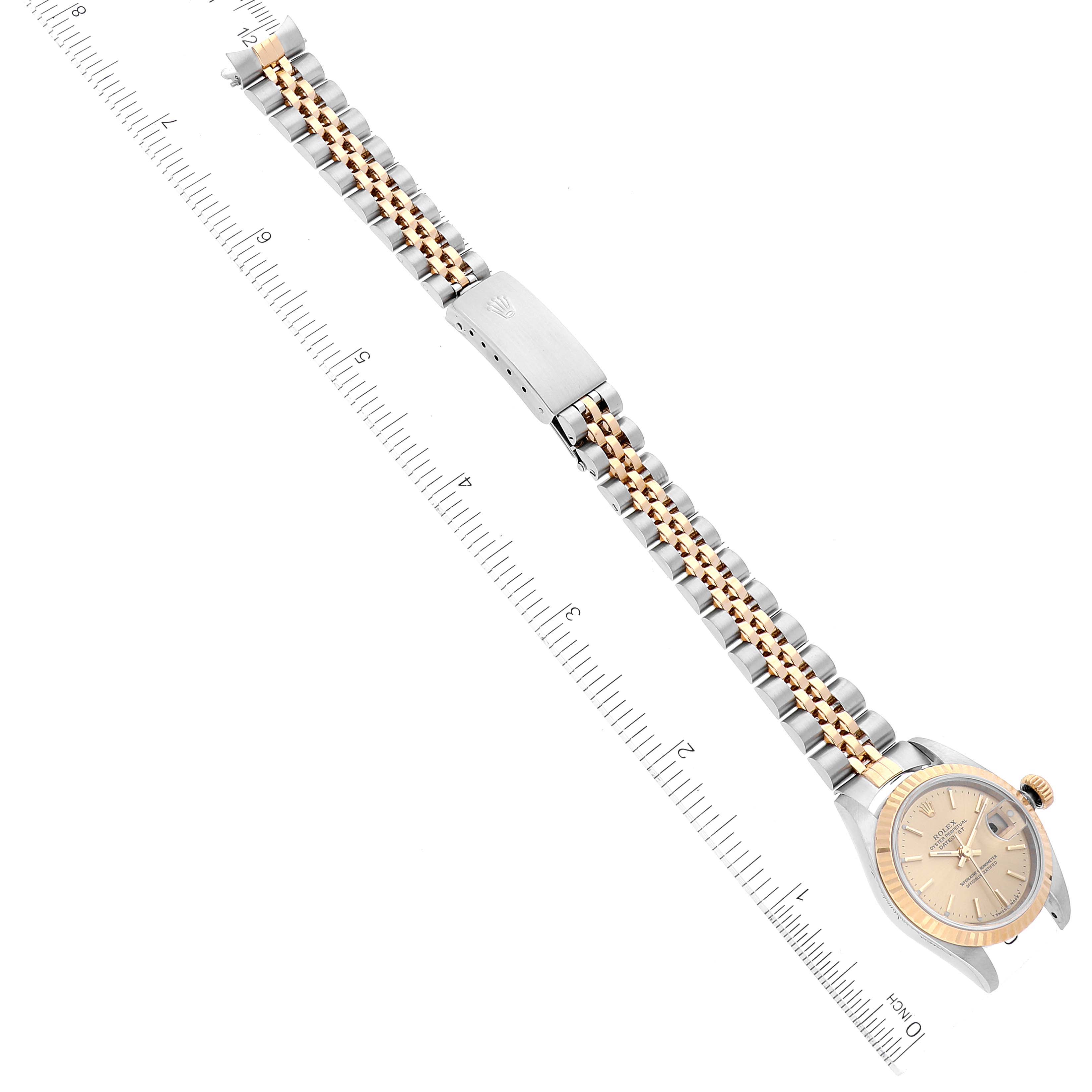 The image shows a Rolex Datejust 79173 Women's Steel and Gold (two tone) Champagne Dial 79173 Women's Steel and Gold (two tone) Champagne Dial watch laying flat, displaying its two-tone bracelet and clasp, measured against a ruler.