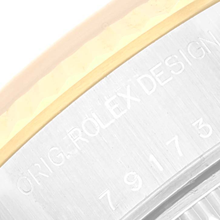 This image shows a close-up of the engraved text on the side of the bezel of a Rolex Datejust 79173 Women's Steel and Gold (two tone) Champagne Dial 79173 Women's Steel and Gold (two tone) Champagne Dial watch.