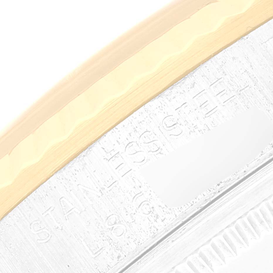 This image shows a close-up of the stainless steel and gold bezel of a Rolex Datejust 16233 Men's Steel and Gold (two tone) Champagne Dial 16233 Men's Steel and Gold (two tone) Champagne Dial watch.