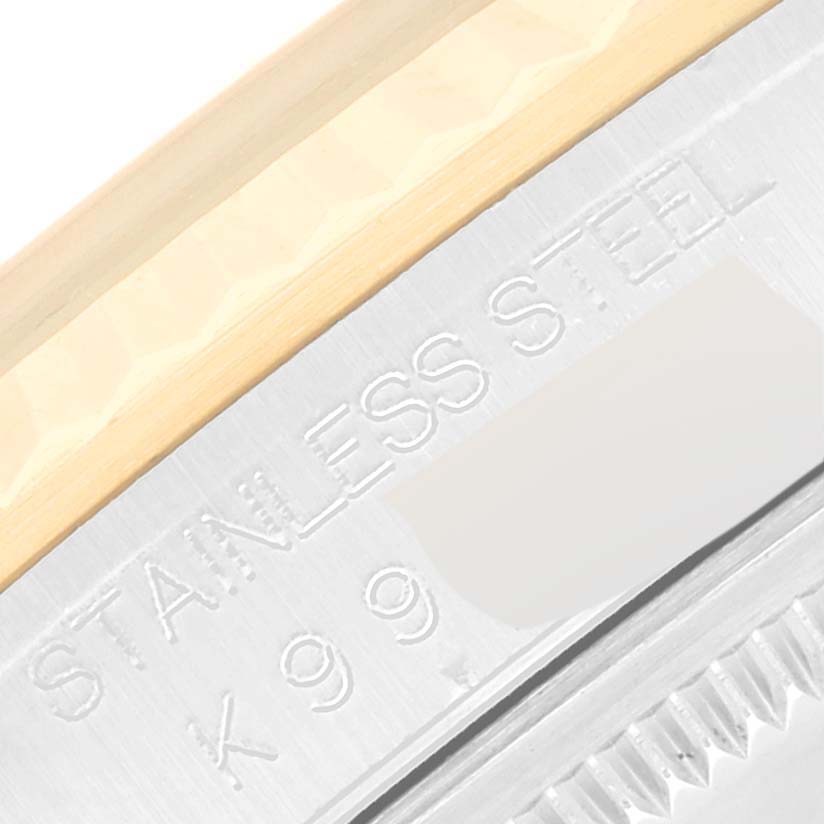 The image shows an extreme close-up of the serial number engraving on the case side of a Rolex Datejust 16233 Men's Steel and Gold (two tone) Mother of Pearl Dial 16233 Men's Steel and Gold (two tone) Mother of Pearl Dial watch.