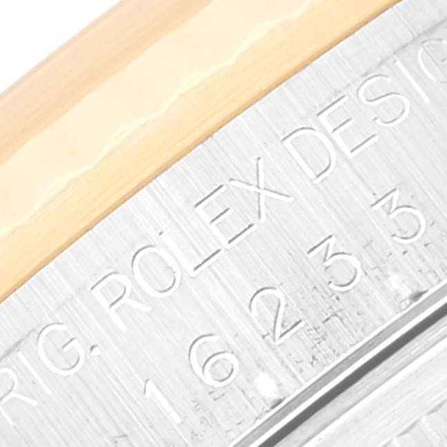 The image shows an angled close-up of the case side and engraved bezel of a Rolex Datejust 16233 Men's Steel and Gold (two tone) Mother of Pearl Dial 16233 Men's Steel and Gold (two tone) Mother of Pearl Dial watch.