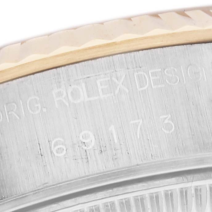 This image shows a close-up of the engraved side of the bezel and case of a Rolex Datejust 69173 Women's Steel and Gold (two tone) White Dial 69173 Women's Steel and Gold (two tone) White Dial watch.