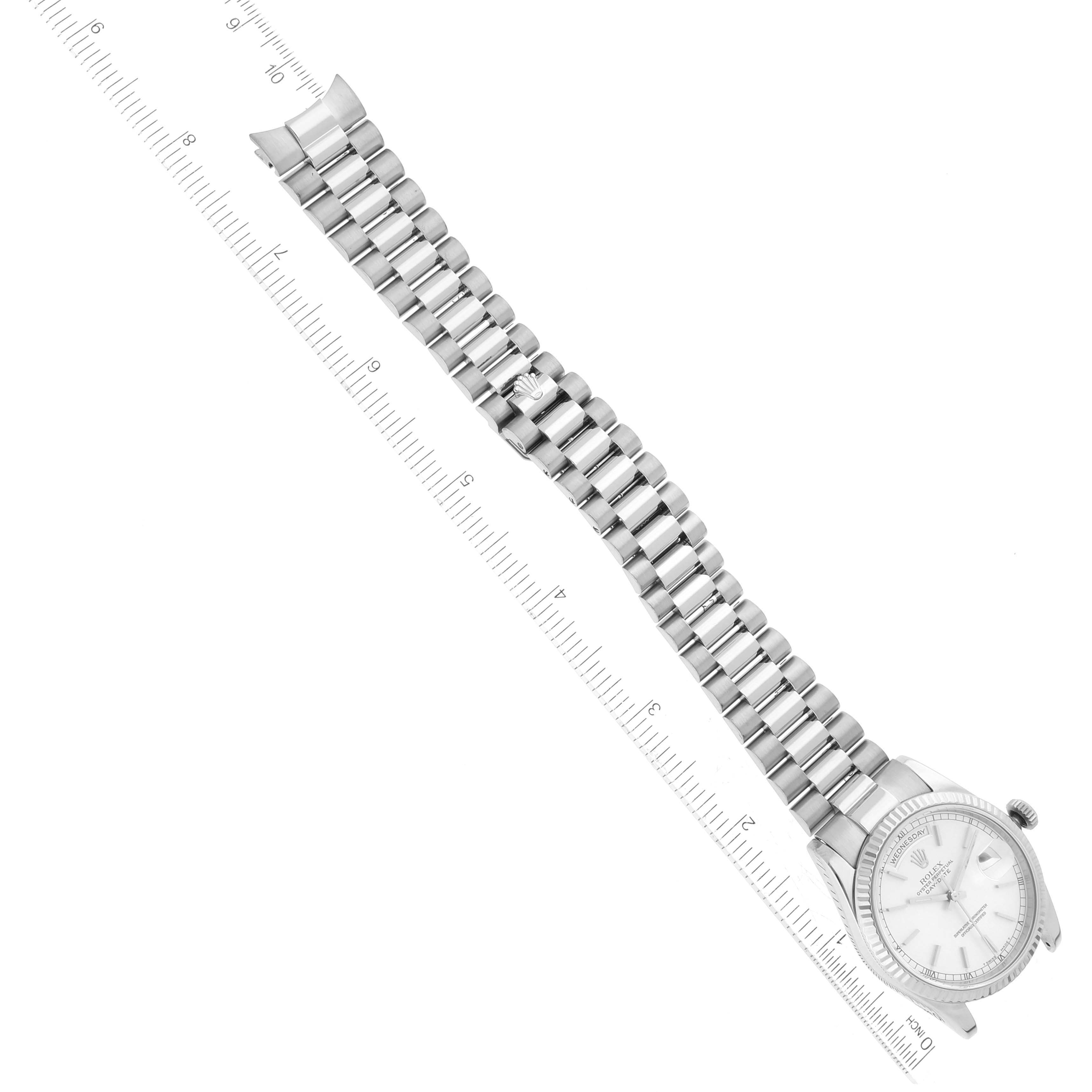 The image shows the Rolex President 118239 Men's White Gold Silver Dial 118239 Men's White Gold Silver Dial model watch laid flat, highlighting the face, bezel, bracelet, and clasp alongside a ruler.