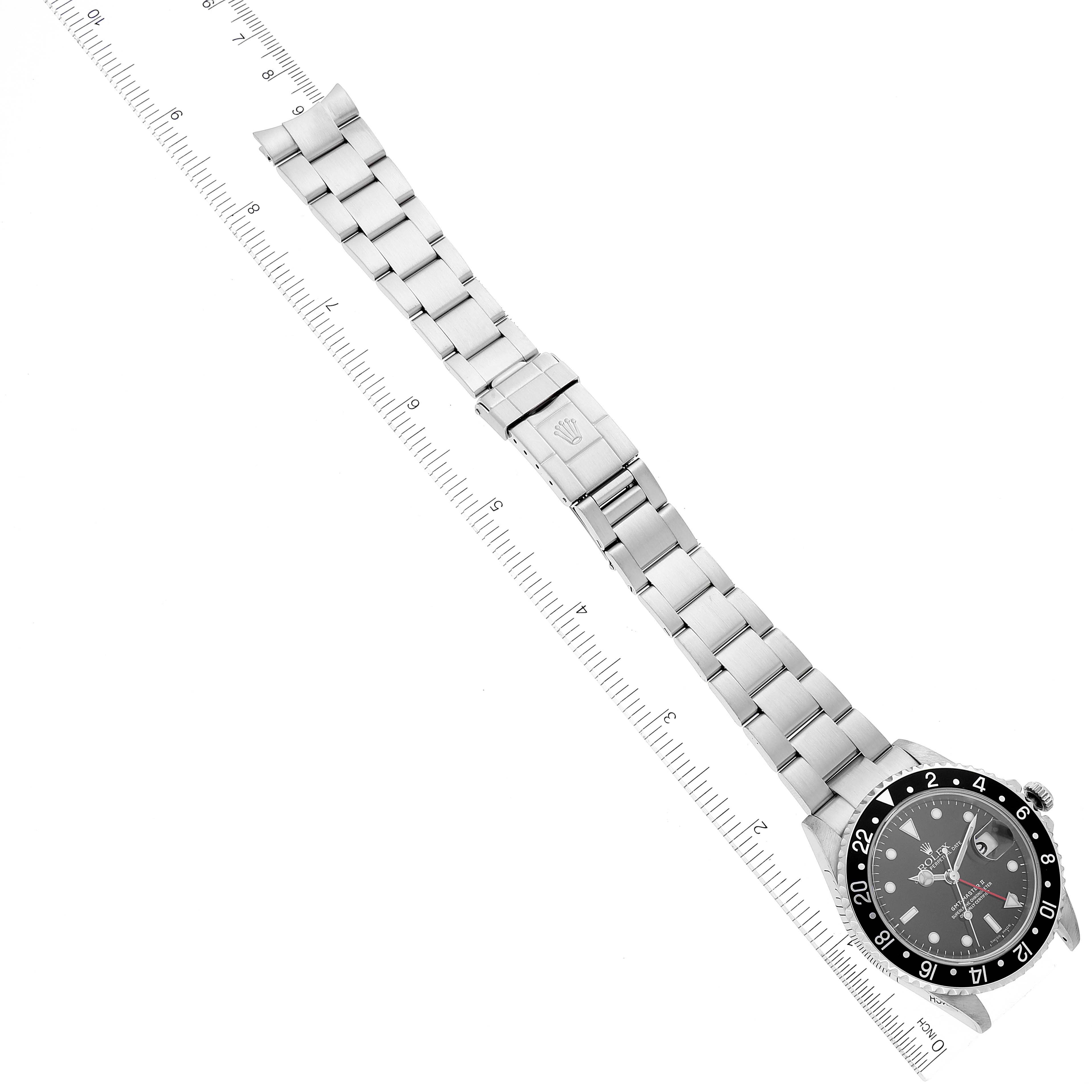 This image shows the Rolex GMT-Master 16710 Men's Stainless Steel Black Dial 16710 Men's Stainless Steel Black Dial watch laid flat with a focus on its bracelet, clasp, and face.