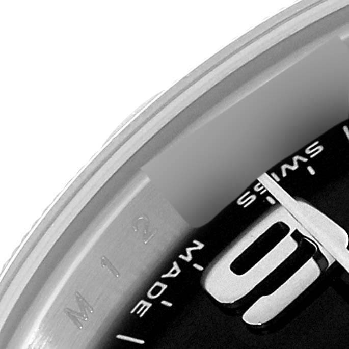 This close-up image shows part of the dial and hand of a Rolex Oyster Perpetual 176210 Women's Stainless Steel Black Dial 176210 Women's Stainless Steel Black Dial watch, alongside the "SWISS MADE" inscription.
