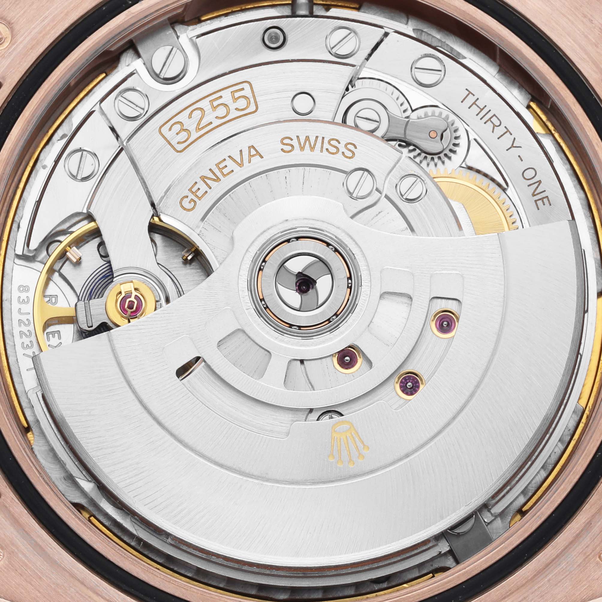 The image shows the movement of the Rolex President 228235 Men's Rose Gold Brown Dial 228235 Men's Rose Gold Brown Dial model, highlighting the rotor and intricate mechanical components.