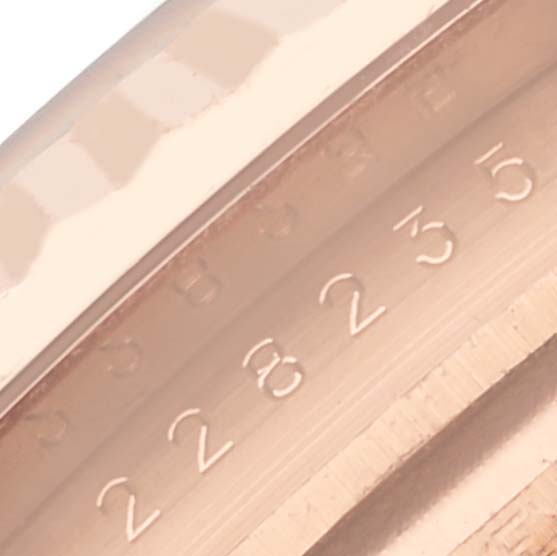 The image shows a close-up of the bezel and engraved edge of a Rolex President 228235 Men's Rose Gold Brown Dial 228235 Men's Rose Gold Brown Dial watch, highlighting its detail and numbering.