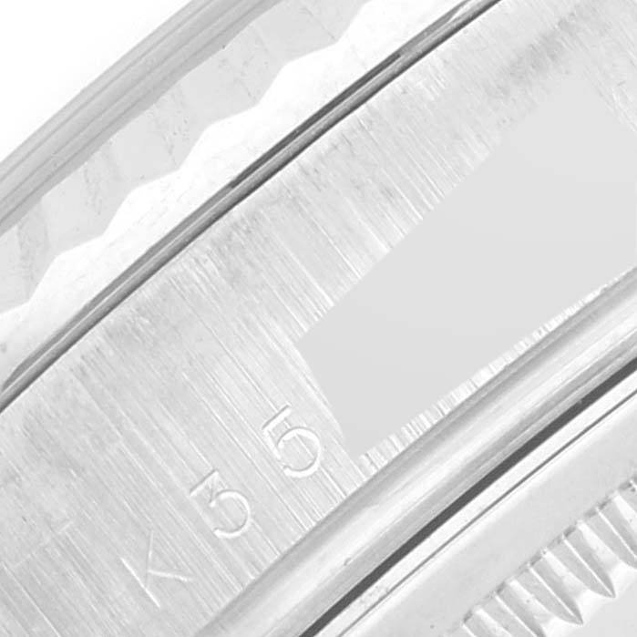 This close-up image shows a portion of the bezel and part of the case back of a Rolex President 118239 Men's White Gold Silver Dial 118239 Men's White Gold Silver Dial model watch.