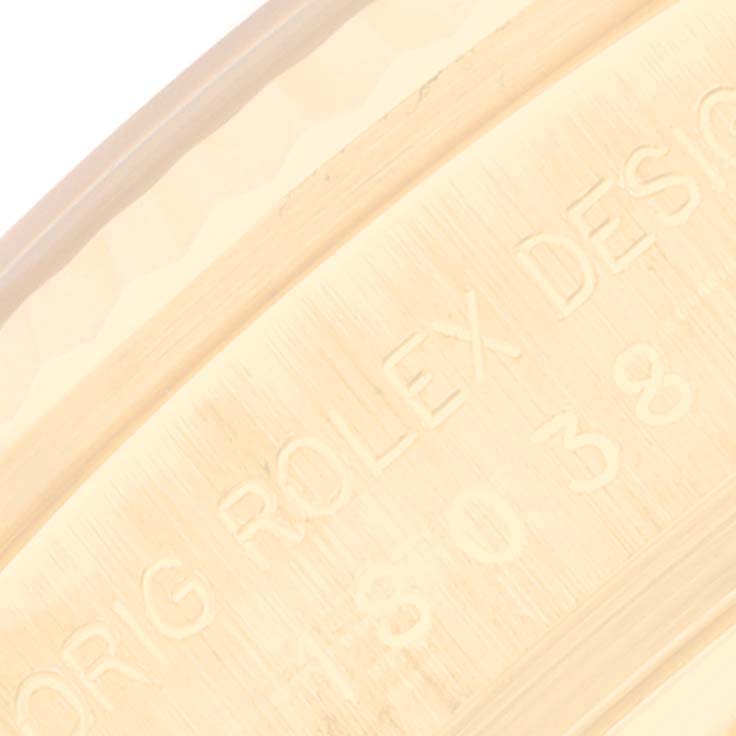 This image shows a close-up of the engraved inner bezel of a Rolex President 18038 Men
s Yellow Gold Champagne Dial 18038 Men
s Yellow Gold Champagne Dial watch, displaying part of the model number and the "Rolex Design" inscription.