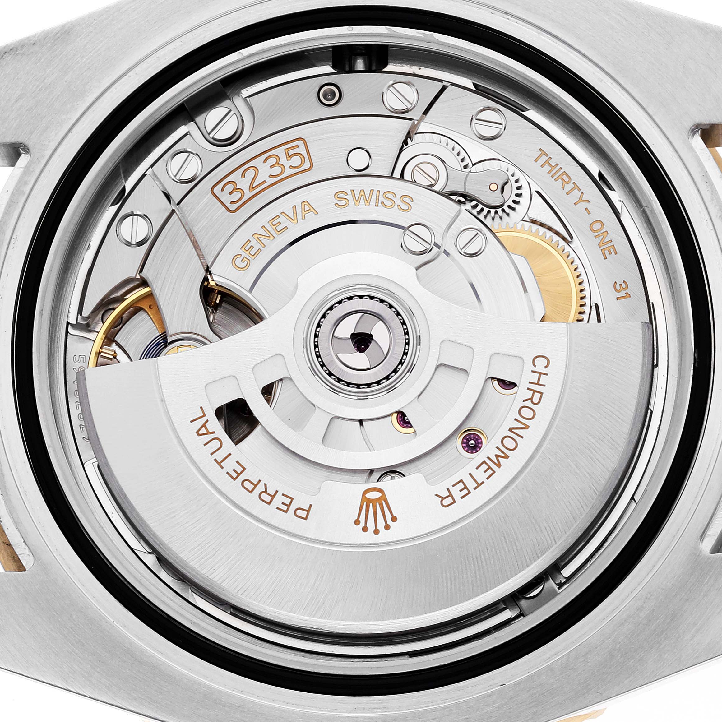 The image shows a close-up view of the movement inside a Rolex Submariner 126613LN Men
s Steel and Gold (two tone) Black Dial 126613LN Men
s Steel and Gold (two tone) Black Dial watch, highlighting the intricate mechanical components.