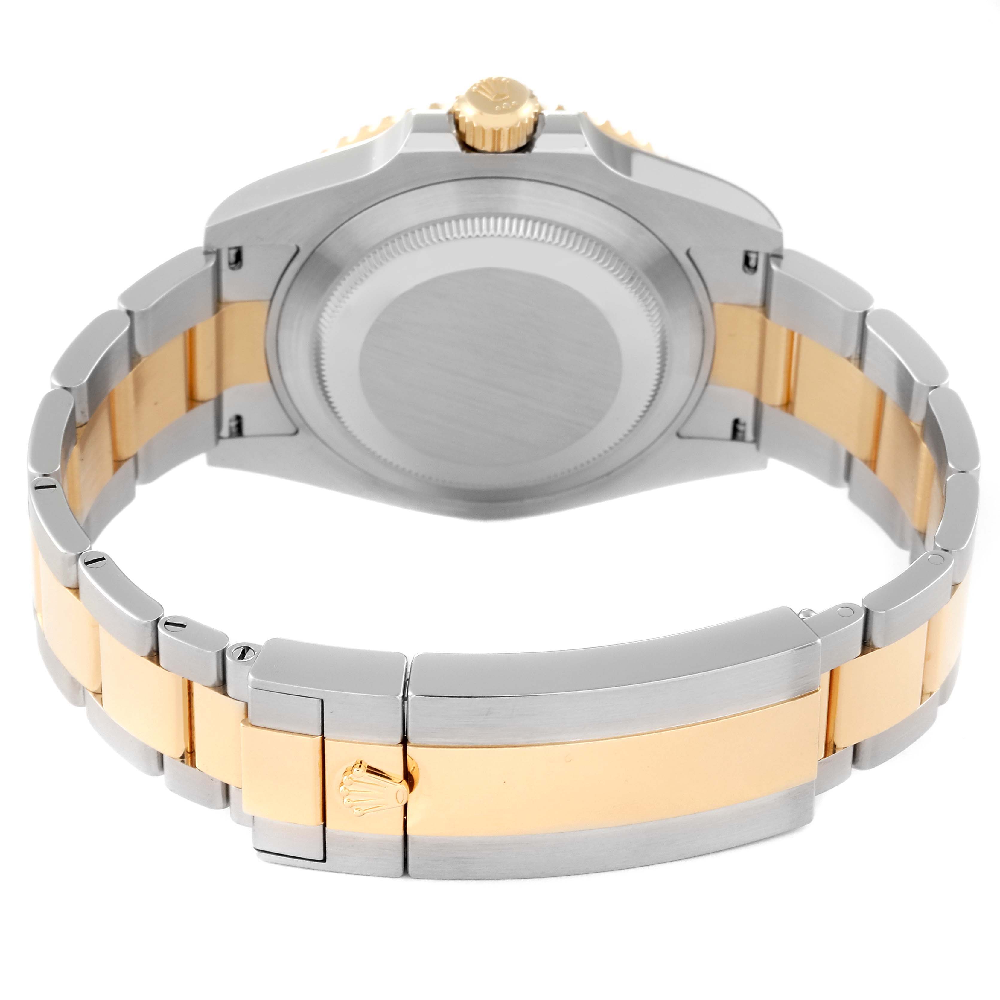 The image shows the back and bracelet of a Rolex Submariner 126613LB Men
s Steel and Gold (two tone) Blue Dial 126613LB Men
s Steel and Gold (two tone) Blue Dial watch in a two-tone metal with the clasp and crown visible.