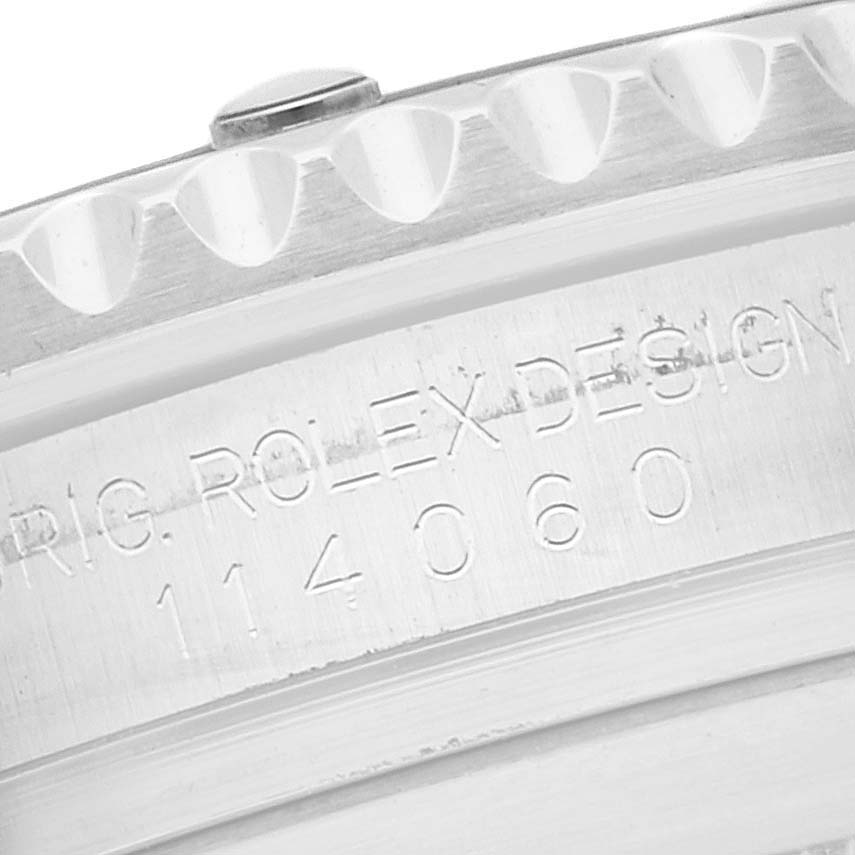 The image shows a close-up angle of the bezel and engraved serial number on a Rolex Submariner 114060 Men's Stainless Steel Black Dial 114060 Men's Stainless Steel Black Dial model.