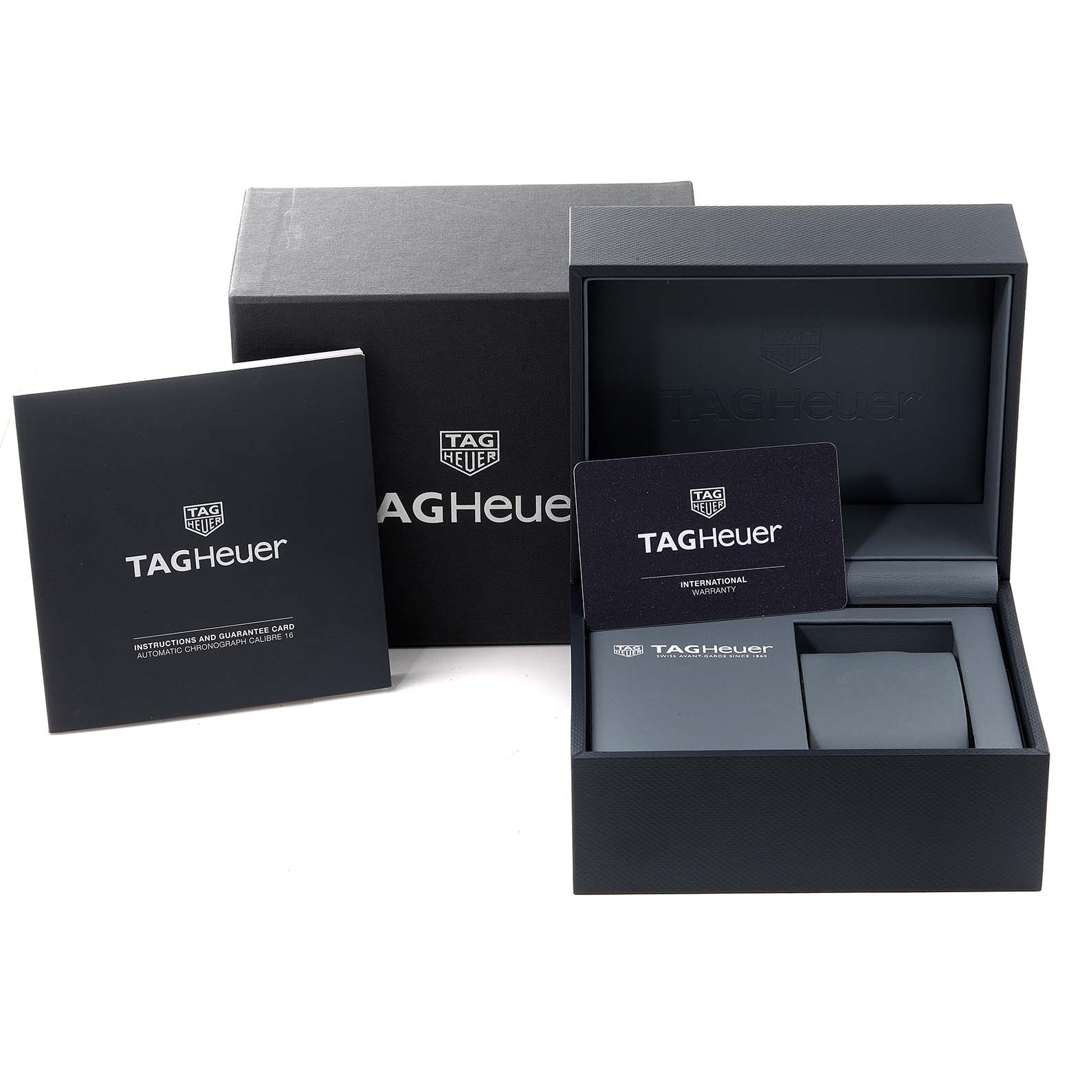 The image shows the packaging and accessories of the Tag Heuer Formula 1 CAZ2012.BA0970 Men's Stainless Steel Grey Dial CAZ2012.BA0970 Men's Stainless Steel Grey Dial watch, including a box, international warranty card, and instruction manual.