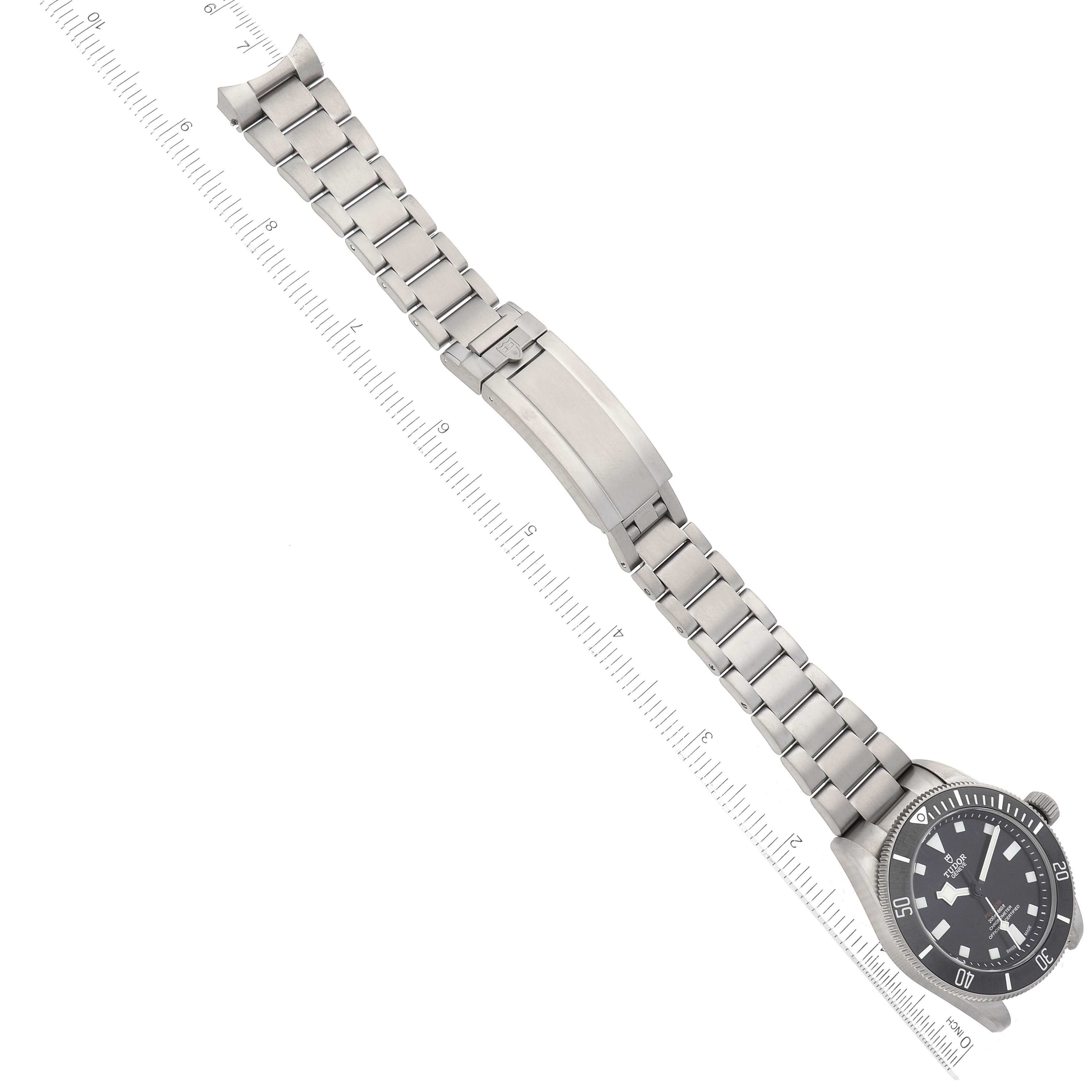 The image shows the Tudor Pelagos 25407N Men
s Titanium Black Dial 25407N Men
s Titanium Black Dial watch from an aerial view, highlighting its stainless steel bracelet and clasp.